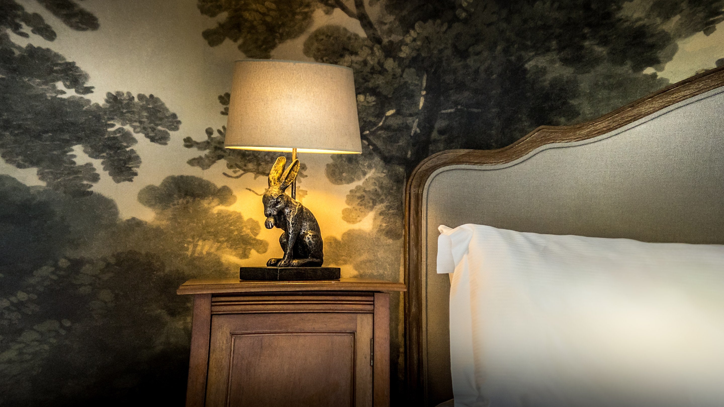 A nightstand with lampstand shaped like a rabbit in one of the king-size bedrooms at Fountains Cottage, Yorkshire