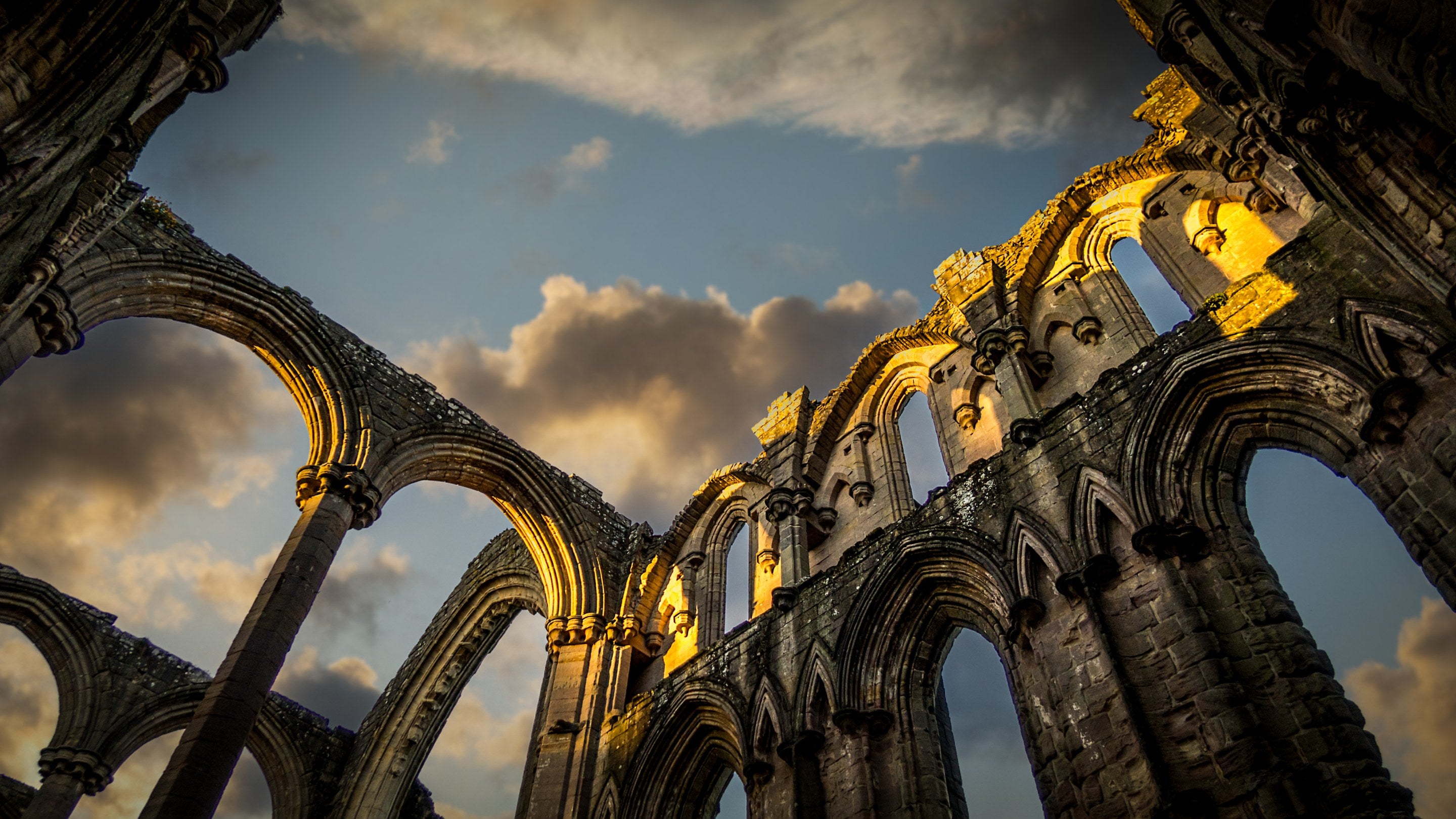 Looking up at stone arches in part of the ruins at Fountains Abbey, Yorkshire