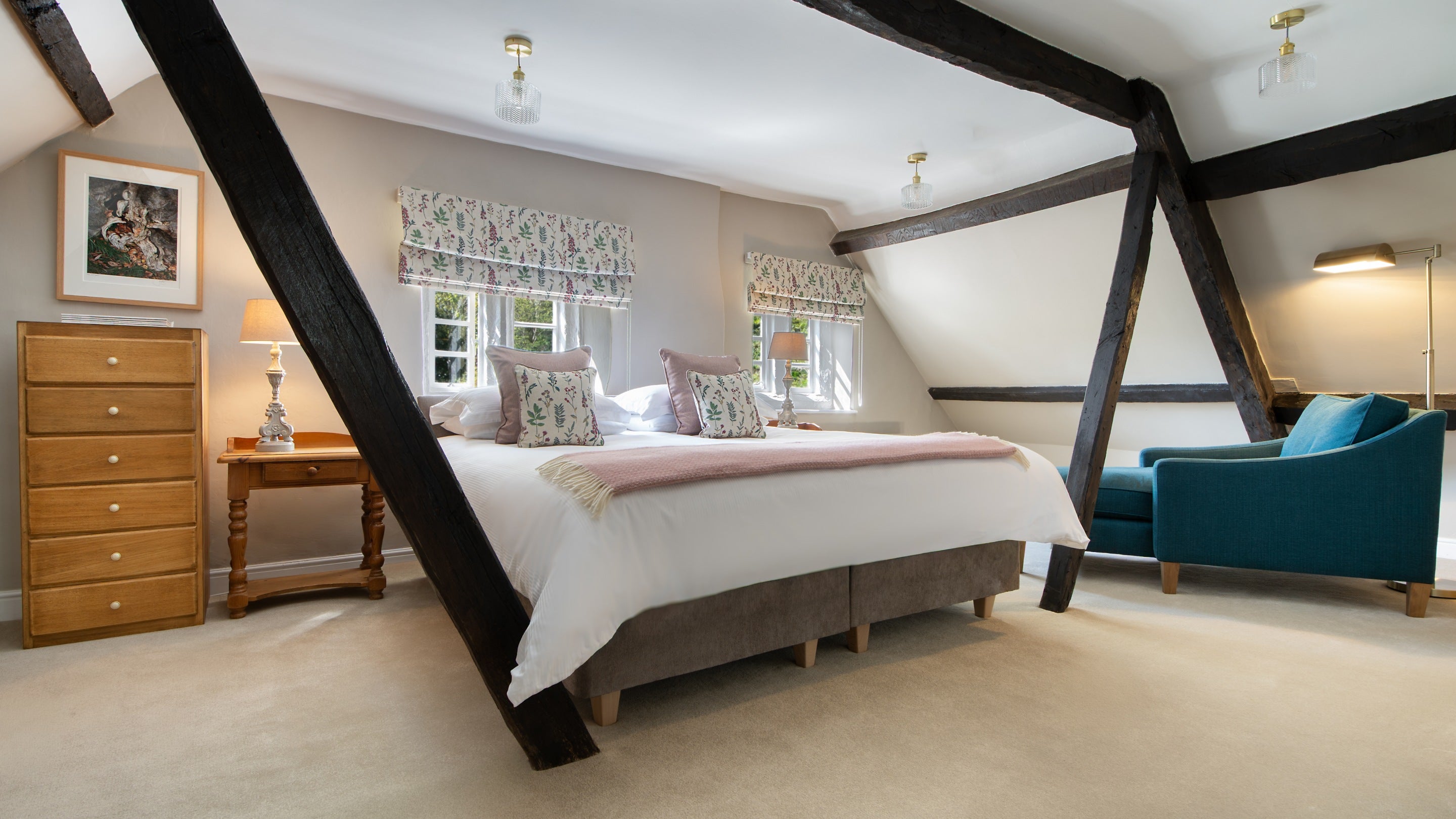 The second-floor double bedroom at Fountains Cottage, which can be made into a twin bed on request. The room has slanted ceilings and a wooden post from the ceiling to the floor on either side of the bed, Yorkshire