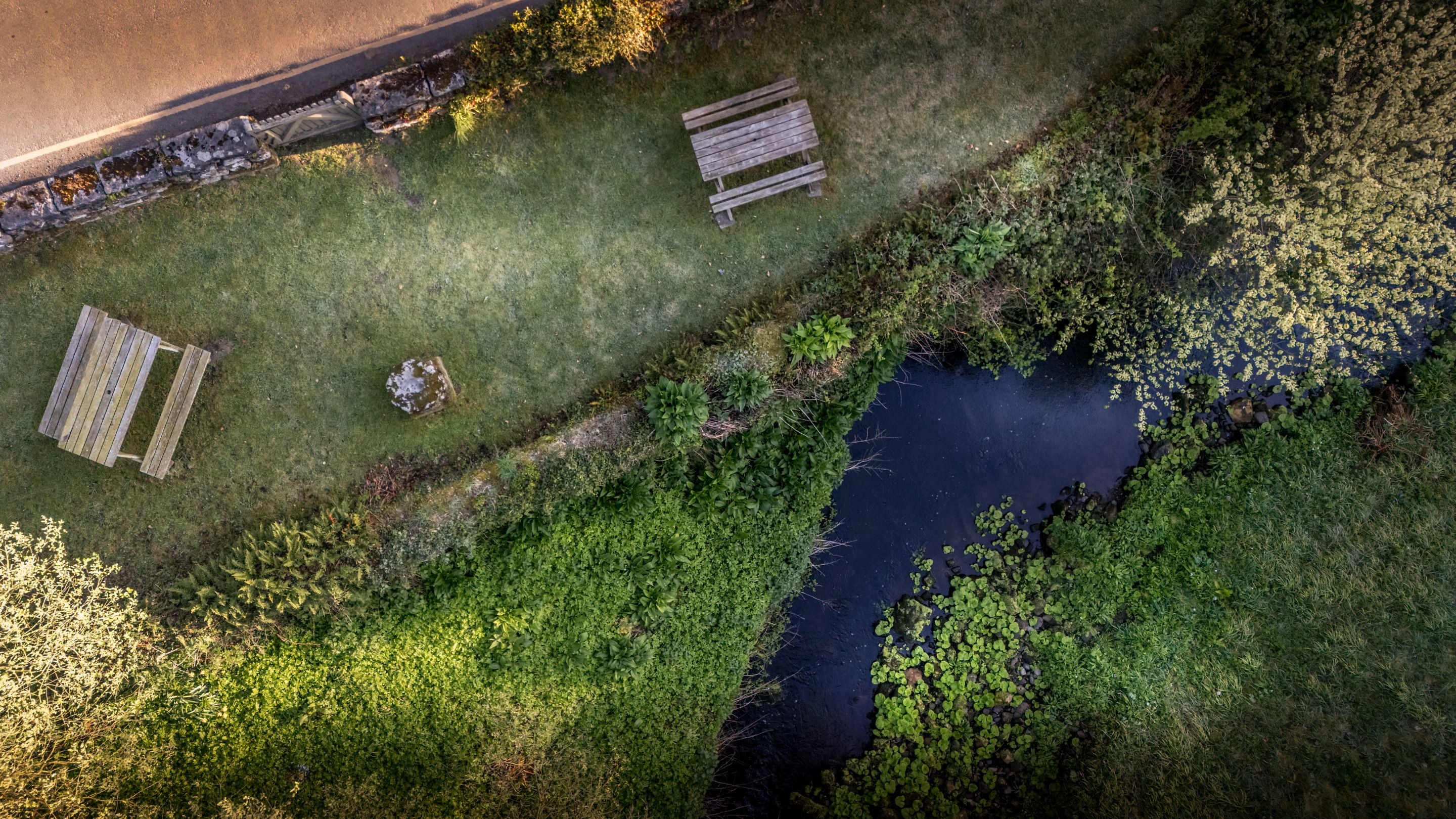 An aerial view of the garden shared by Fountains Cottage, Abbey Stores and Abbey Cottage, and the River Skell flowing past, Yorkshire