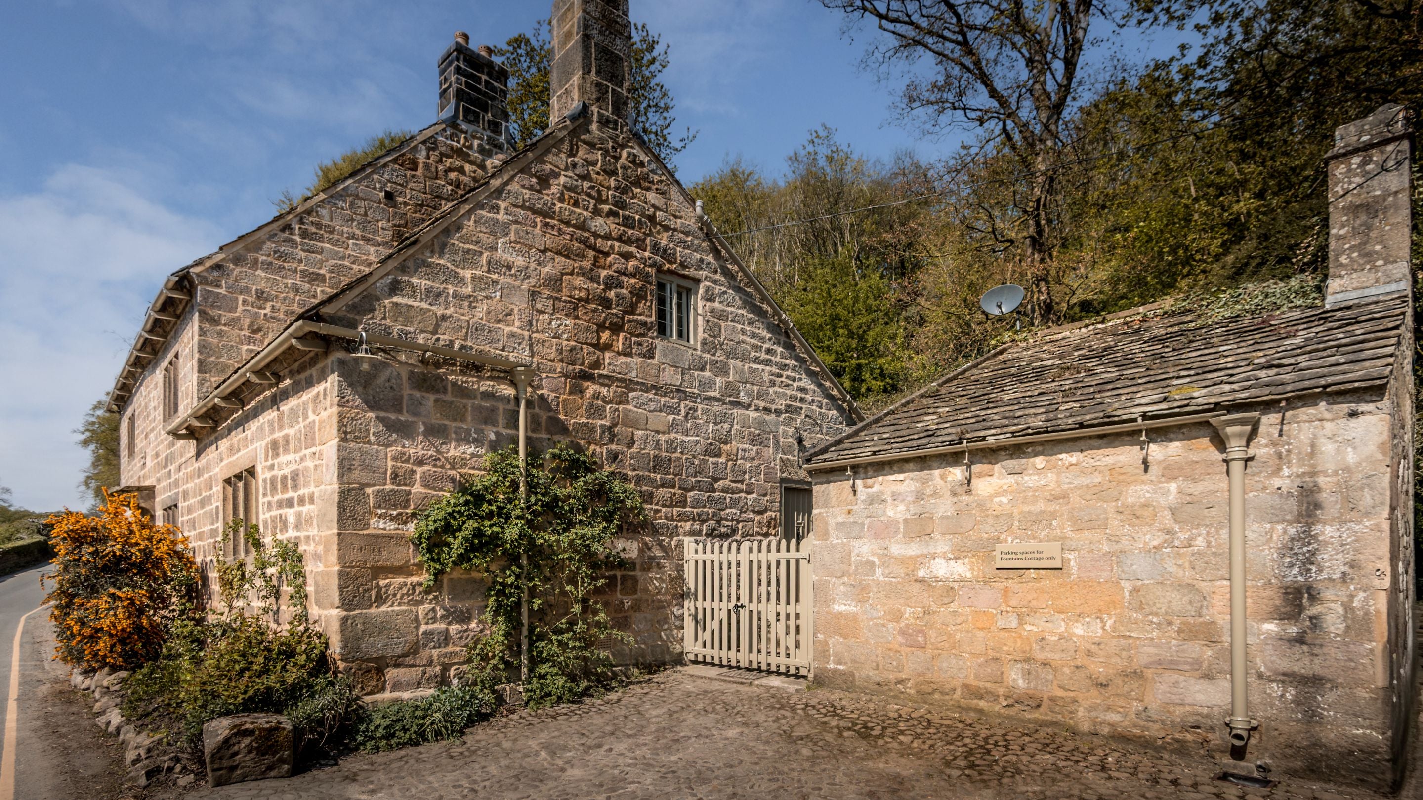 The side of Fountains Cottage and its parking spaces, Yorkshire