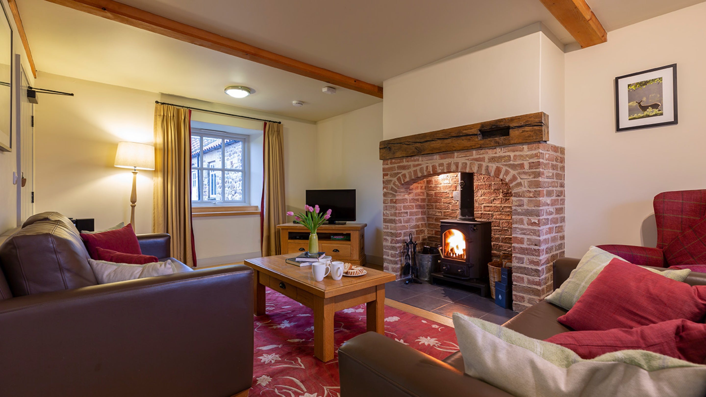 The sitting area with woodburner in the open-plan living space at Lapwing, Yorkshire