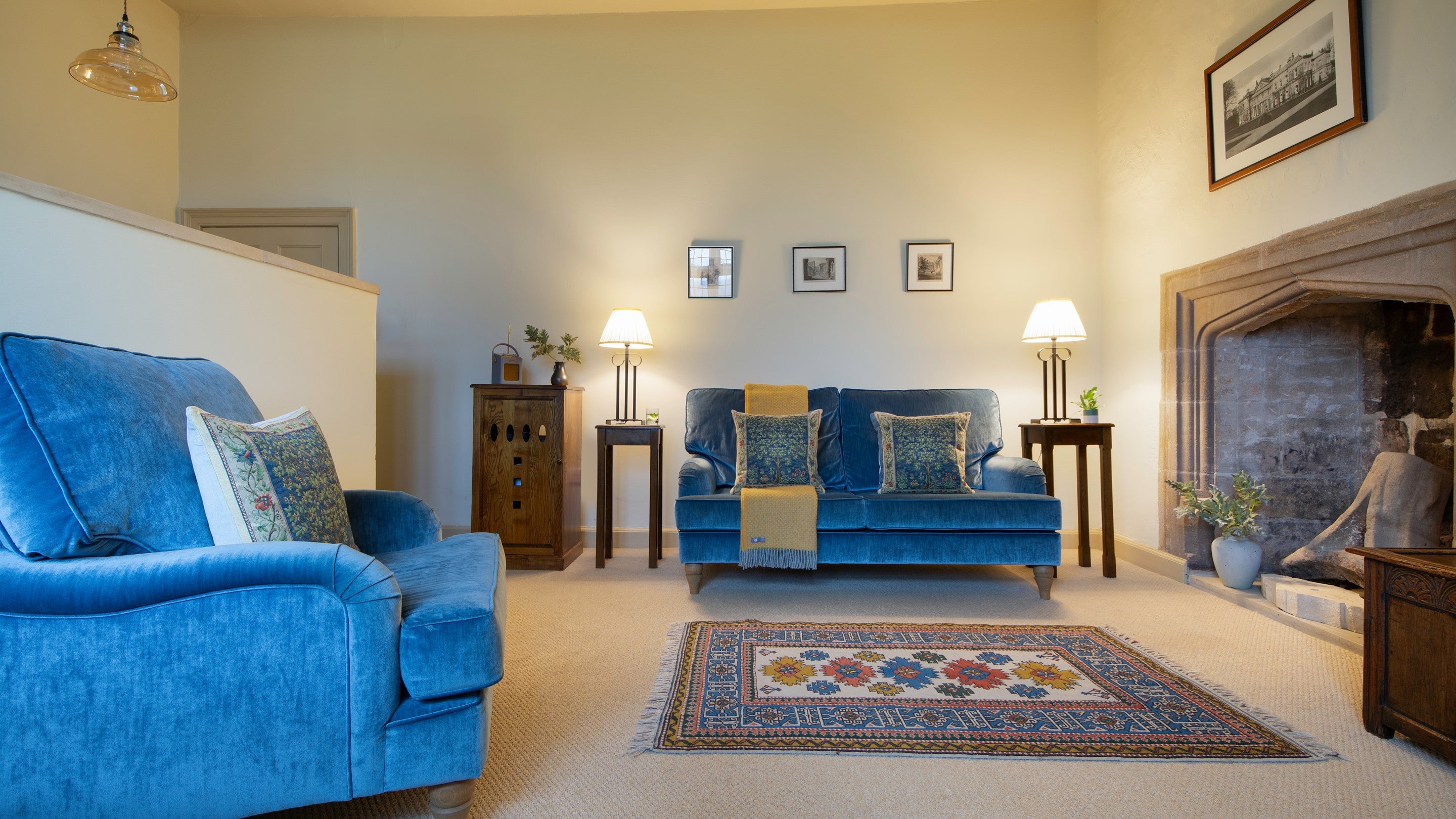 The sitting area with sofa, armchair and fireplace at Proctor, North Yorkshire