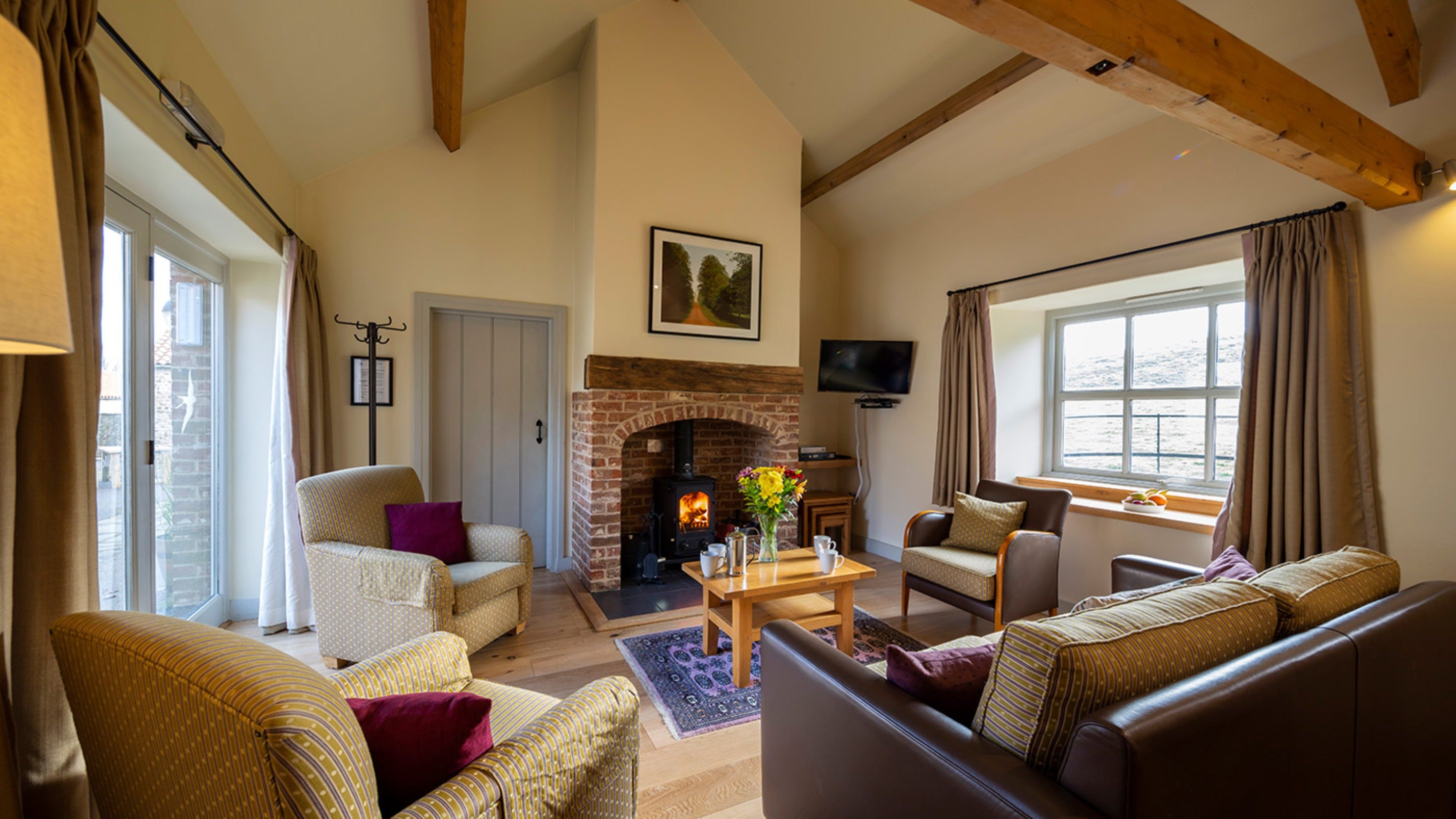 The sitting area with woodburner in the open-plan living space at Swallow, Yorkshire