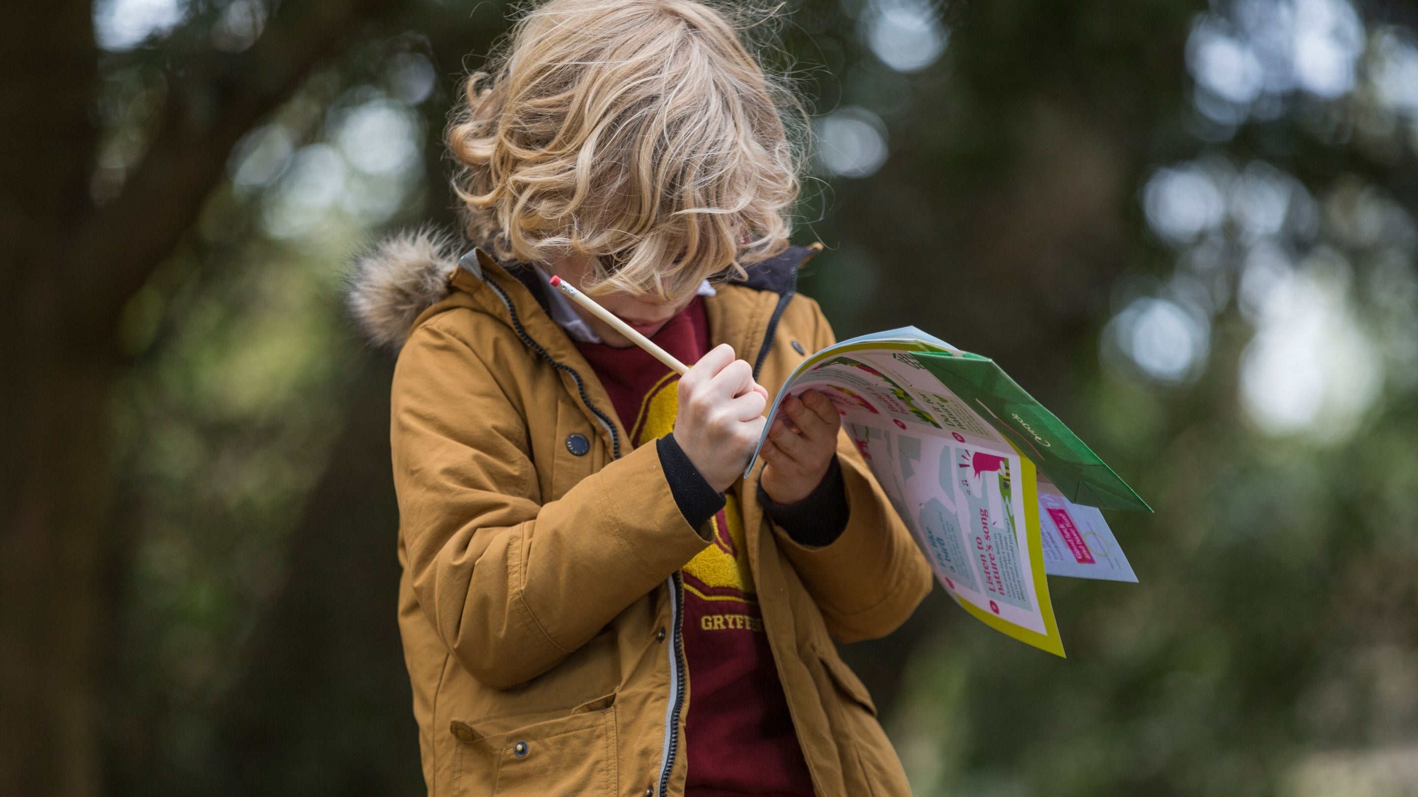 Child fills in their Easter activity trail at Osterley Park and House, West London