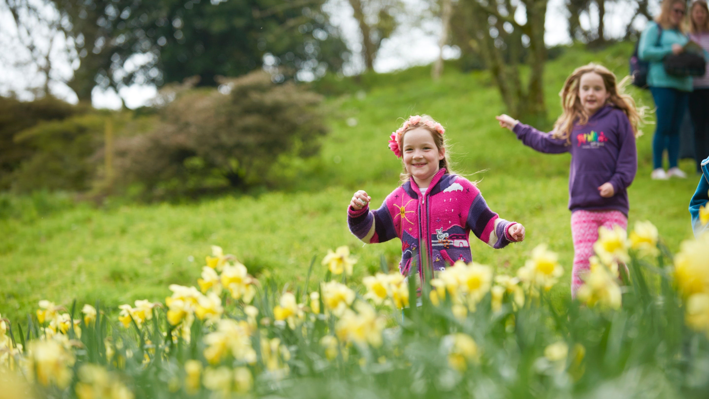 Two children playing in the garden in spring at Coleton Fishacre, South Devon