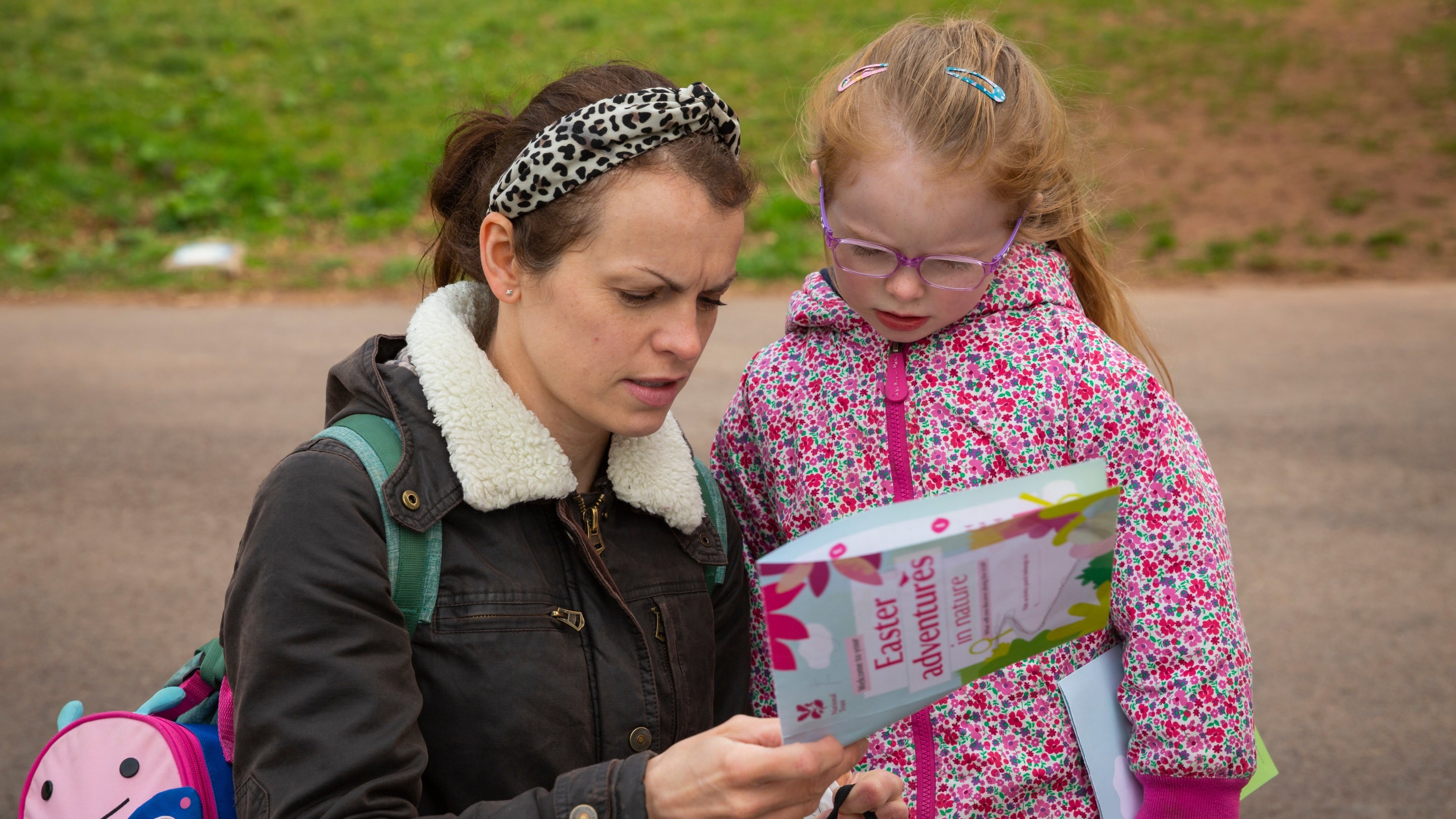 A woman and girl studying the map for the Tyntesfield Easter trail