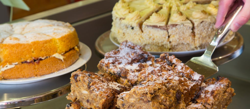 Three types of cake on display in the Stables Cafe at Knightshayes, Devon