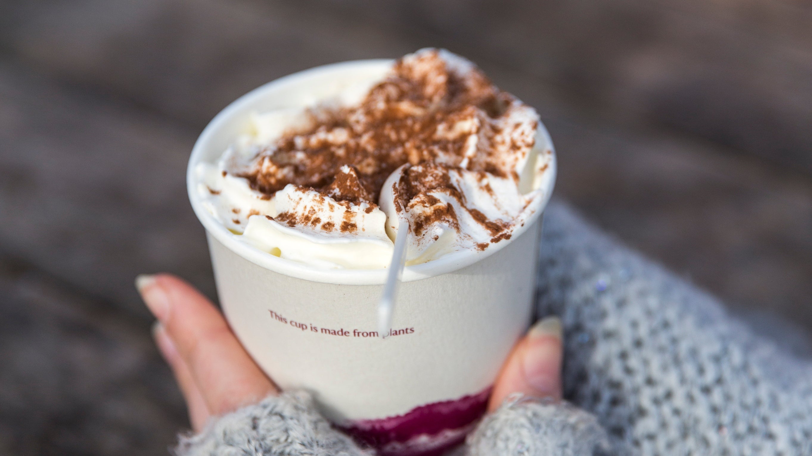 Visitor enjoying a hot drink from the Lake Brew coffee truck at Clumber Park, Nottinghamshire