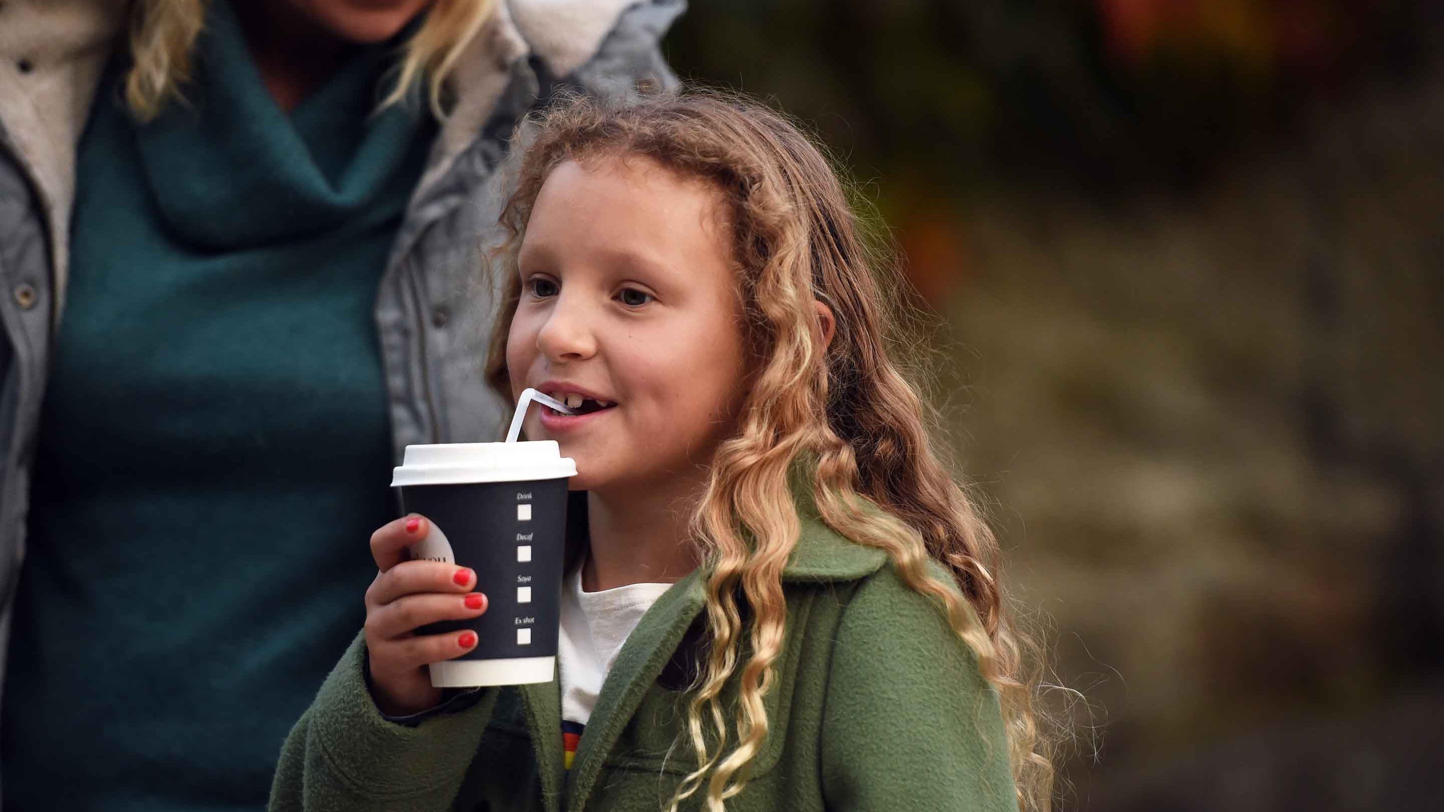 Visitor having a drink in the garden at Sizergh, Cumbria