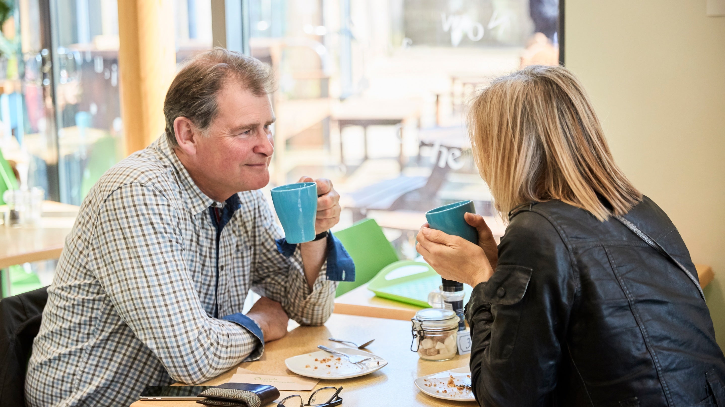 Visitors enjoying hot drinks inside the café at Hardy's Birthplace Visitor Centre at Hardy's Cottage, Dorset