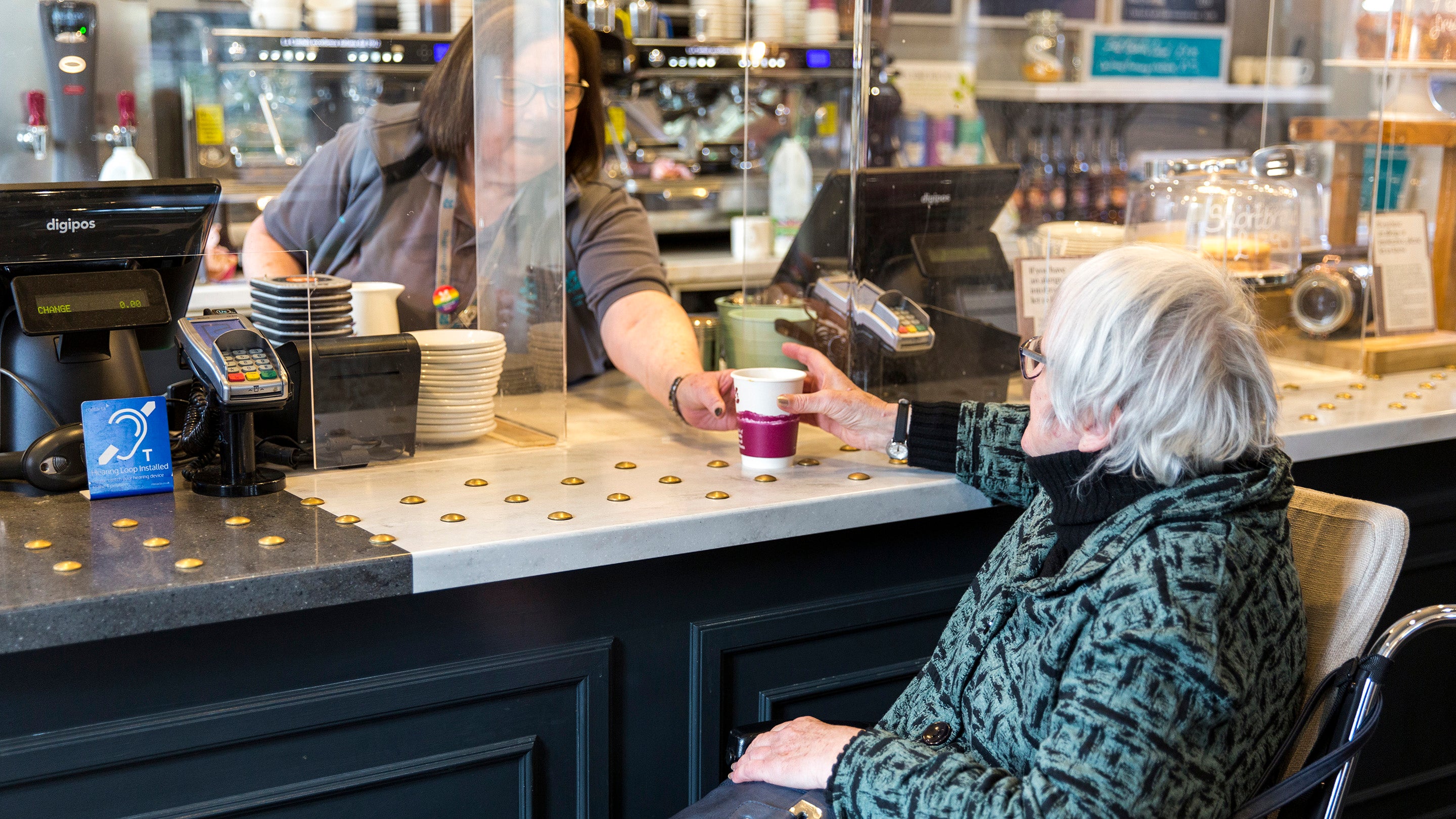 A woman ordering a drink in the Park Farm Cafe at Shugborough Estate, Staffordshire