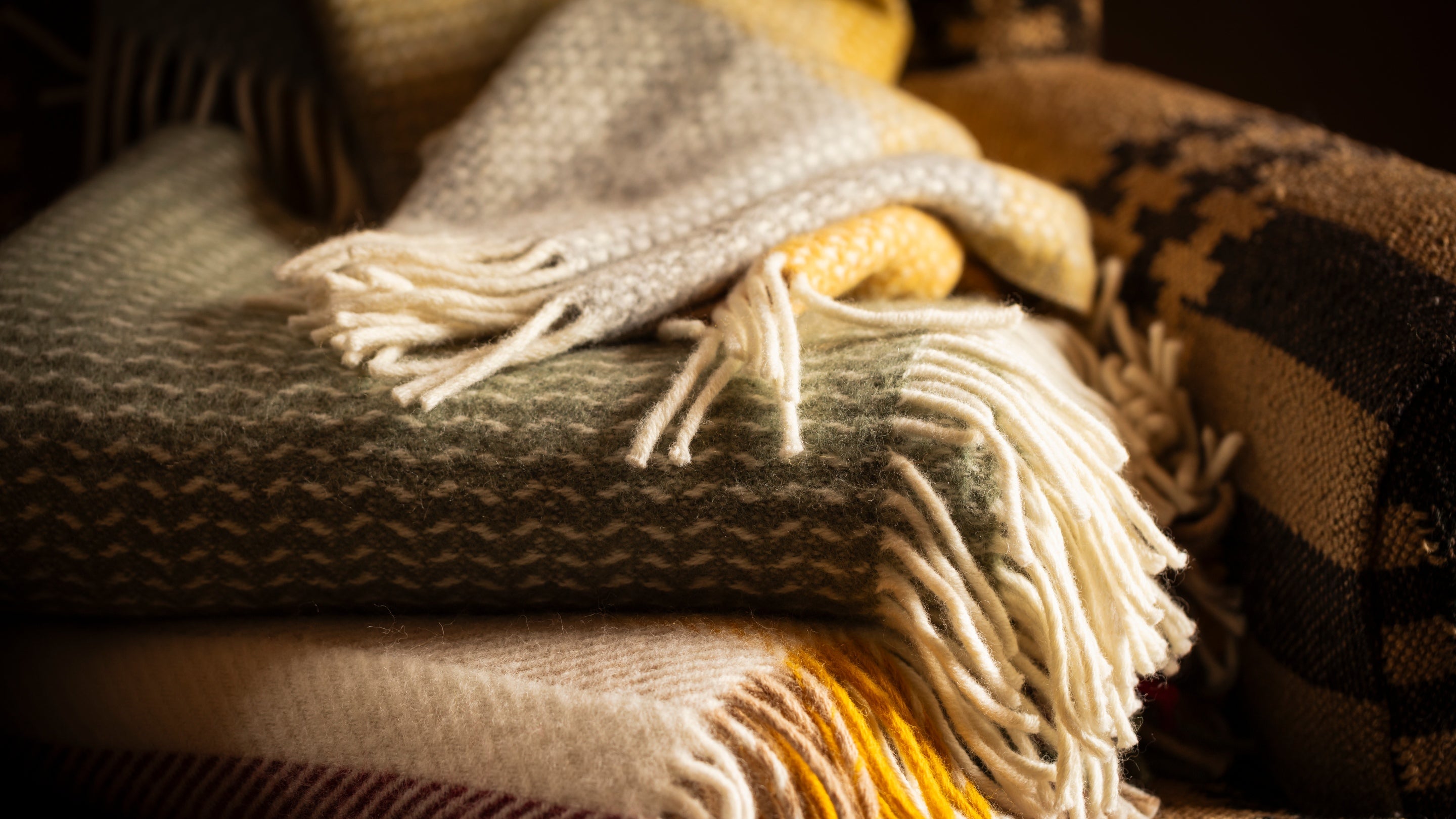 A pile of green and yellow throws
