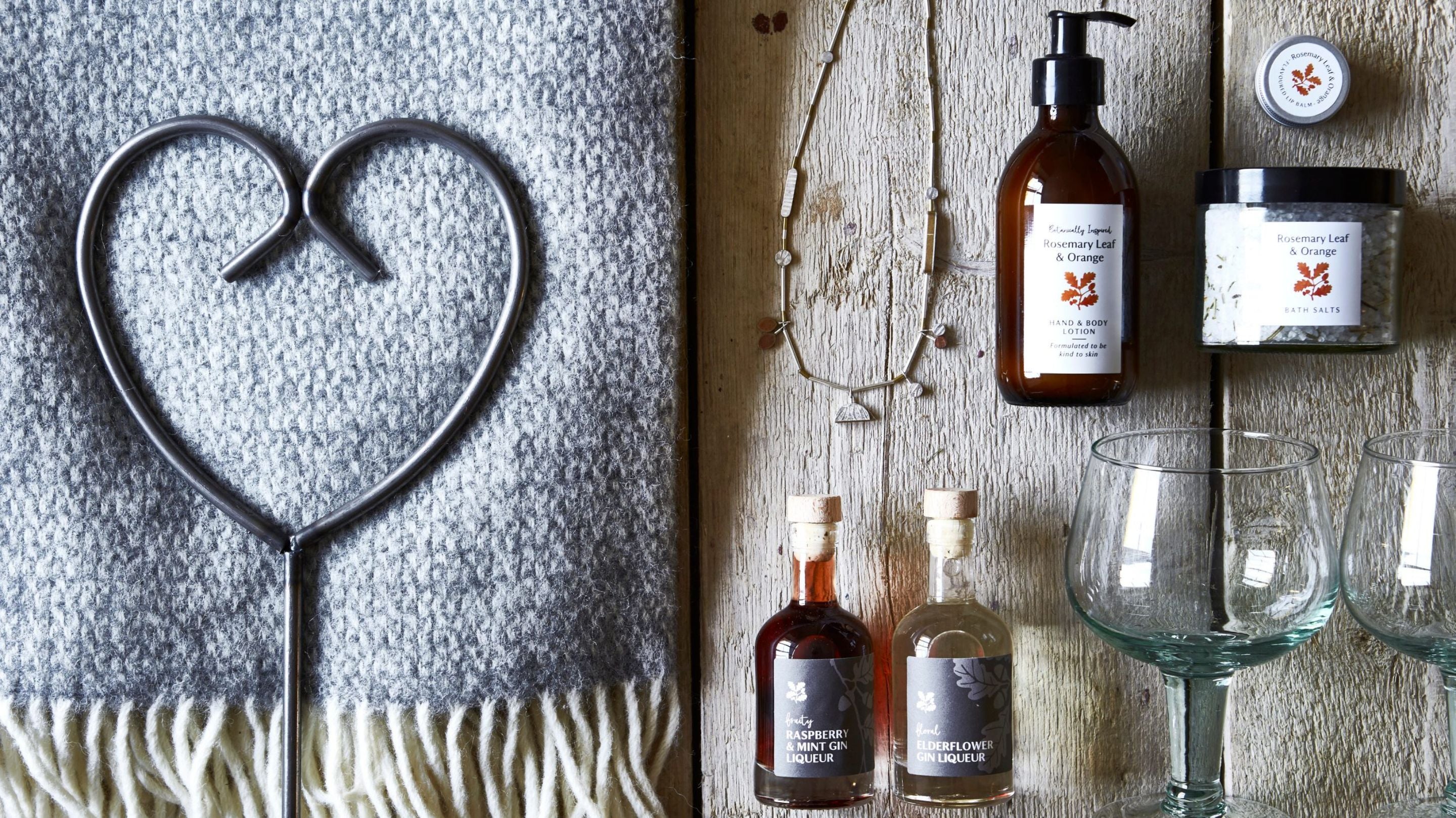 A number of items available to purchase at the gift shop including a scarf, bath salts and glasses