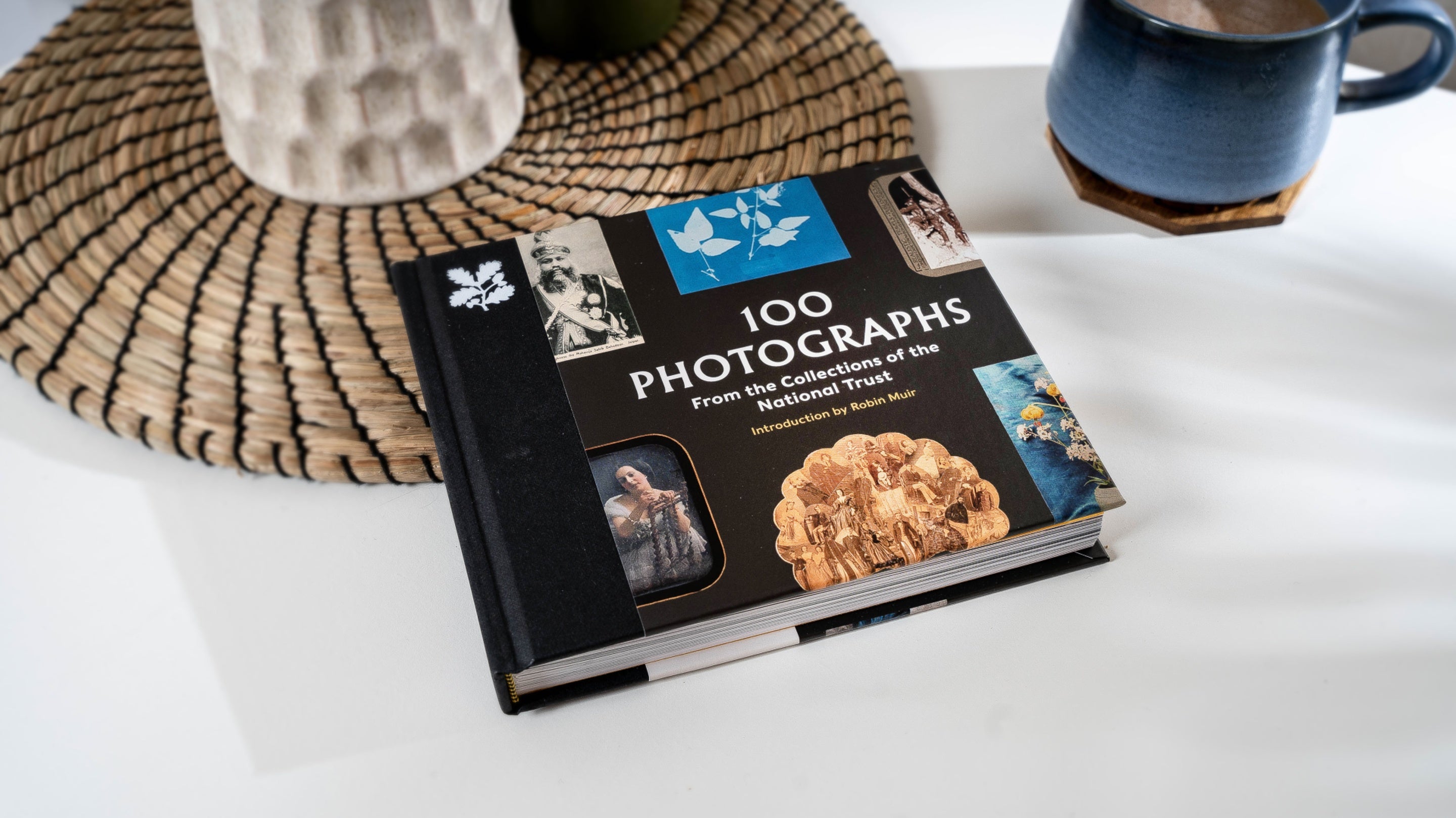 The 100 Photographs Book on a coffee table