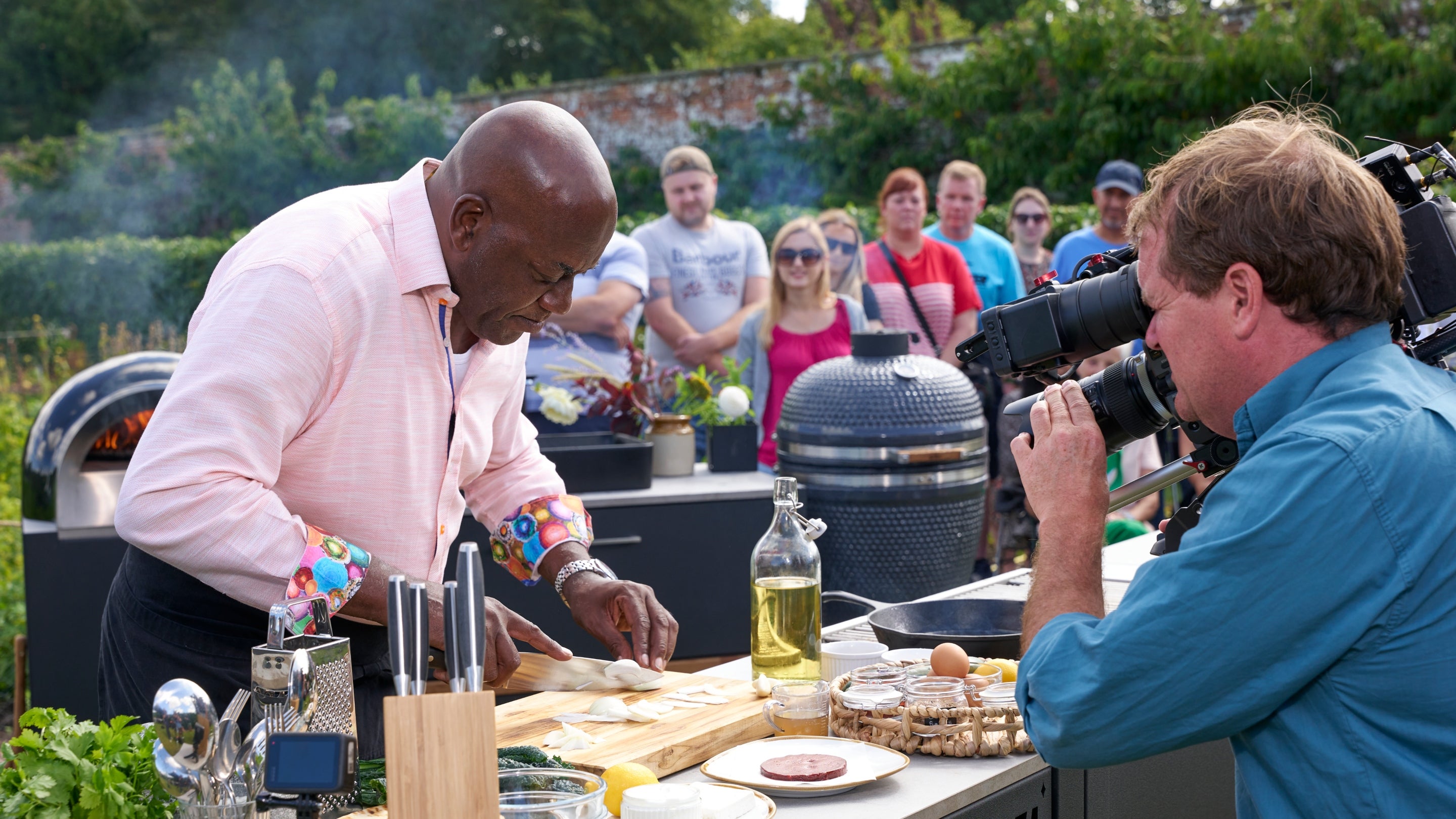 Celebrity chef Ainsley Harriott being filmed cooking in an outdoor kitchen at Wimpole Estate, Cambridgeshire