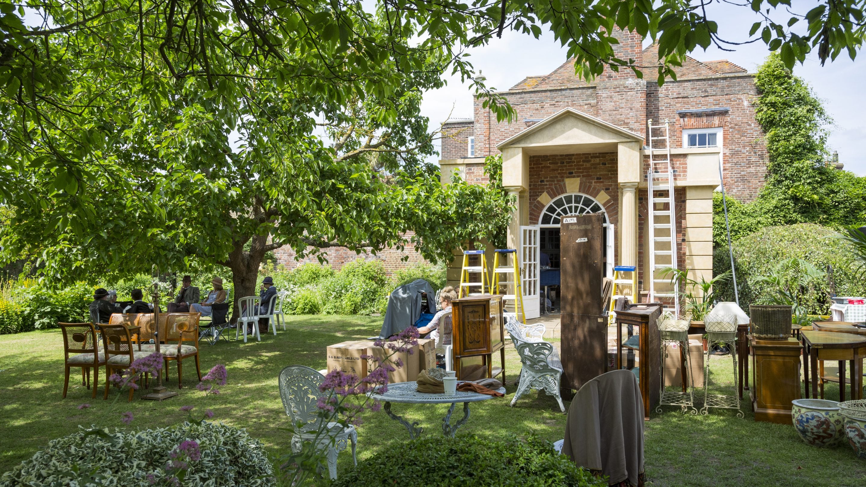 Boxes, ladders and furniture in the garden at Lamb House, East Sussex, during a tv shoot