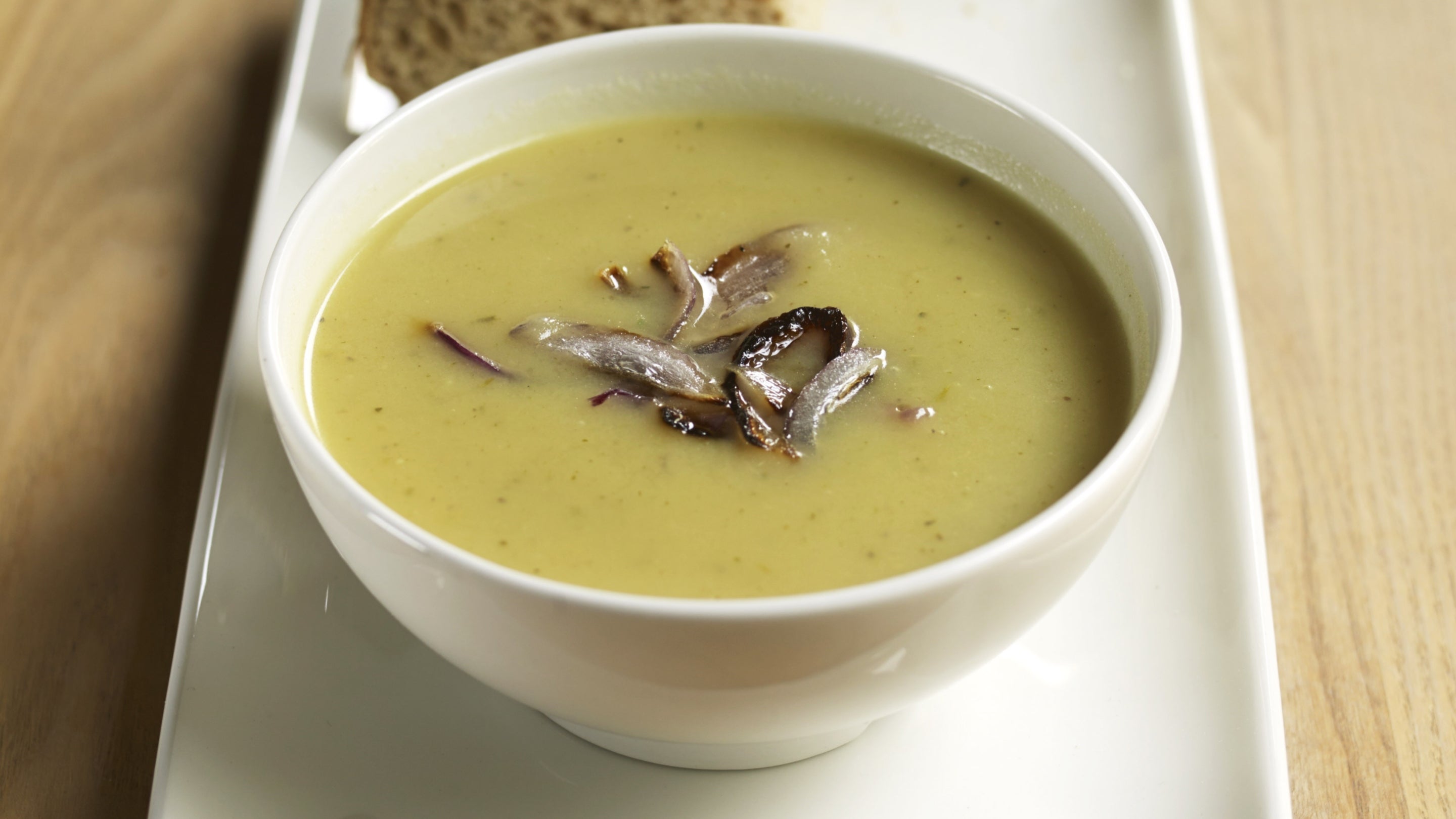 A bowl of our potato and onion soup with an onion topping from a recipe in our Cookbook