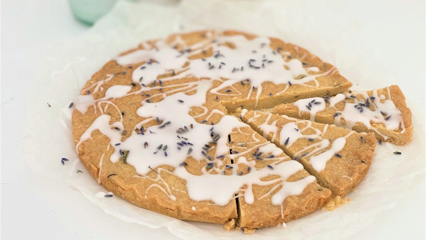 Round lavender shortbread with white icing and dried lavender on top