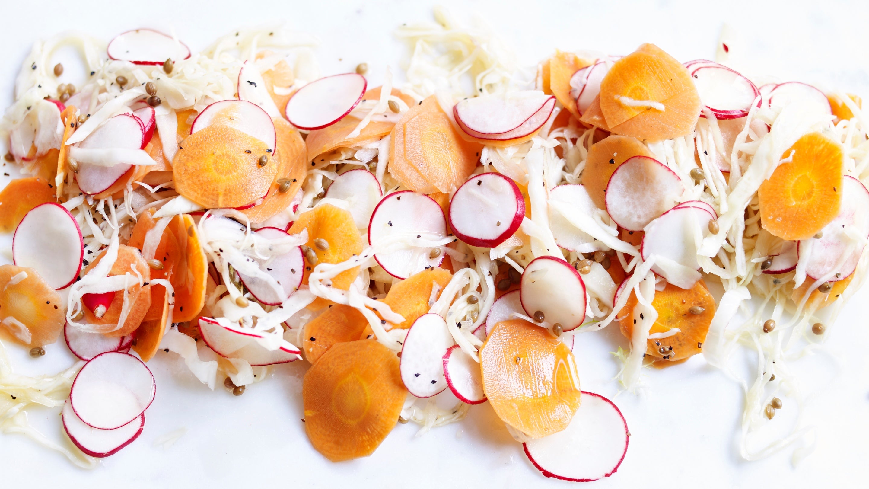 Pickled radish and vegetable slaw: sliced carrots and radishes with shredded cabbage