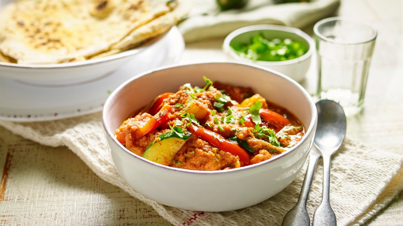 Potato, pepper and courgette curry with naan bread
