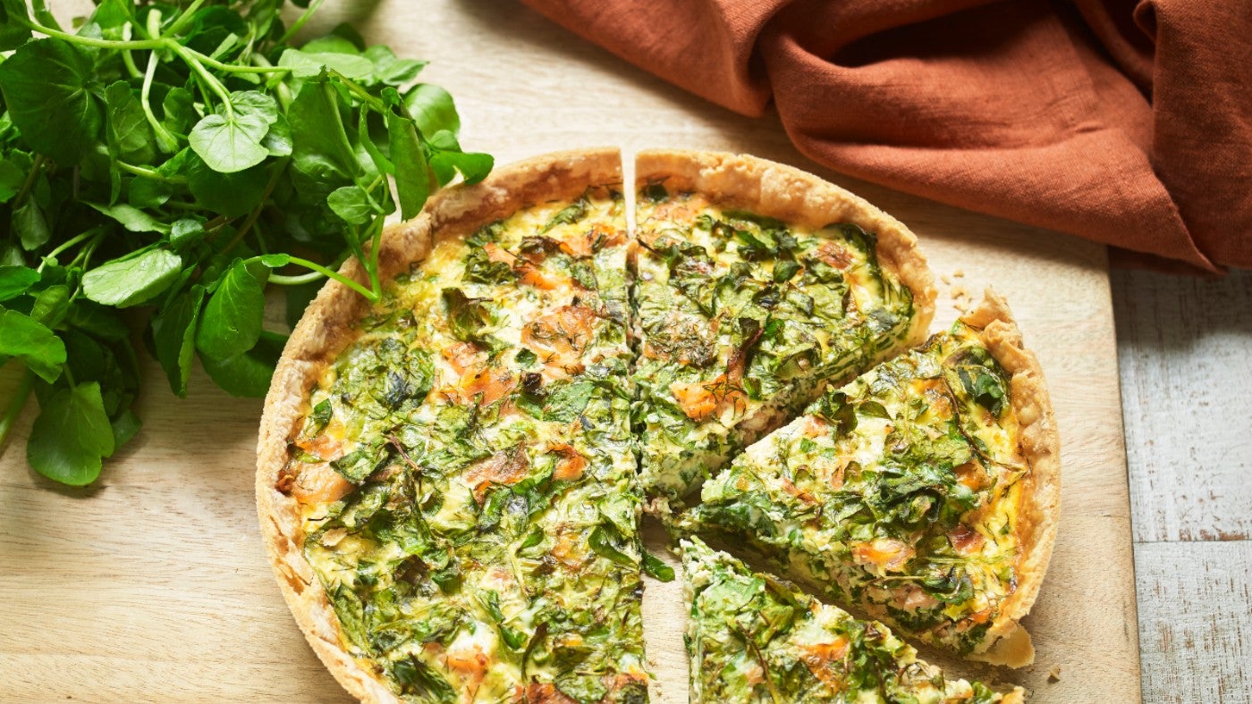 Large baked quiche with salmon and watercress filling