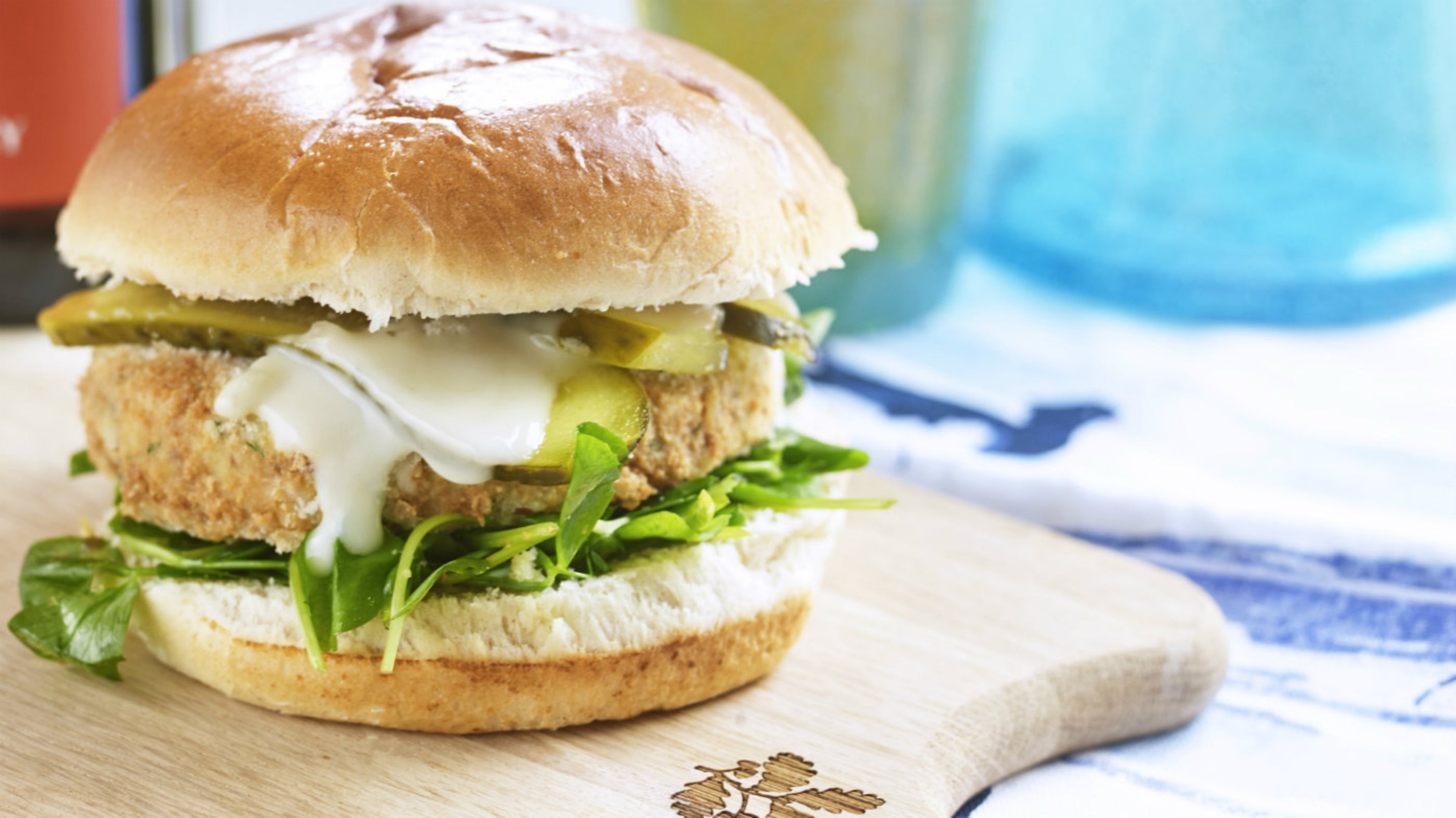 Smoked mackerel fishcake in a brioche roll with gherkins and rocket