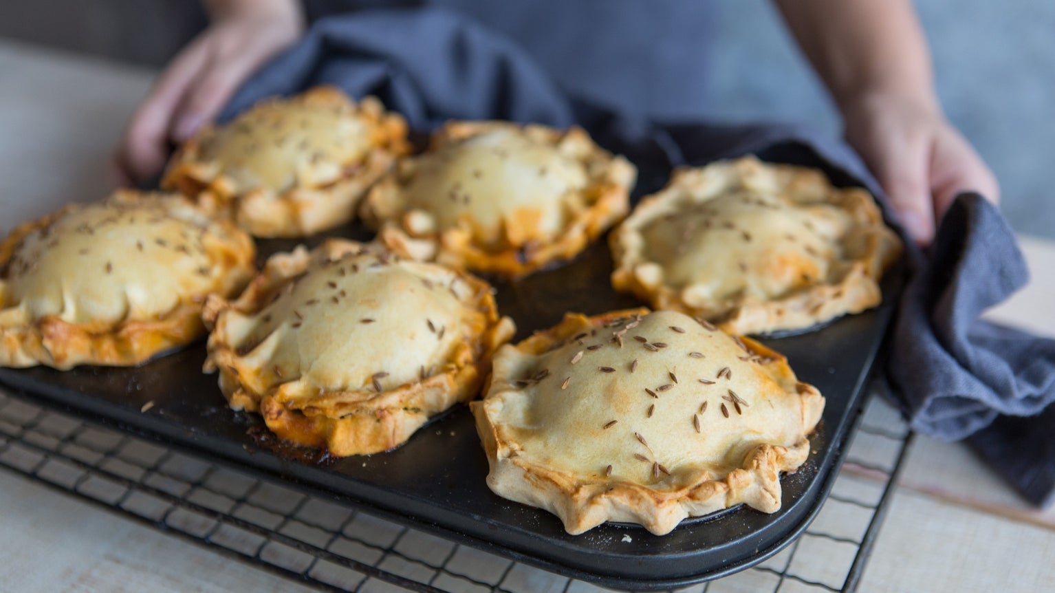 Sweet potato and cauliflower curried pies in a baking tray