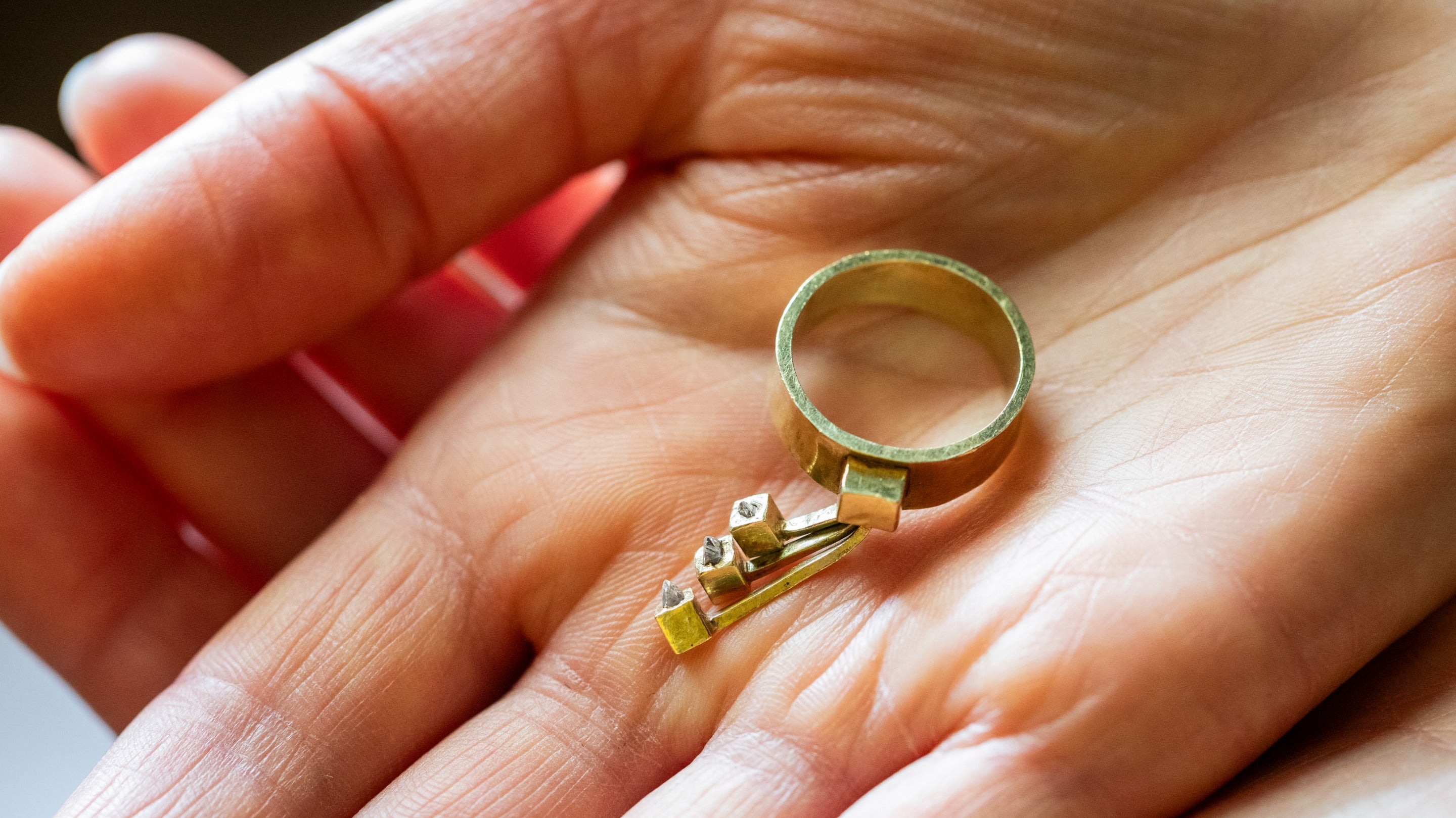 The newly acquired gold and diamond ring designed by Louis Osman, while at Canons Ashby, Northamptonshire