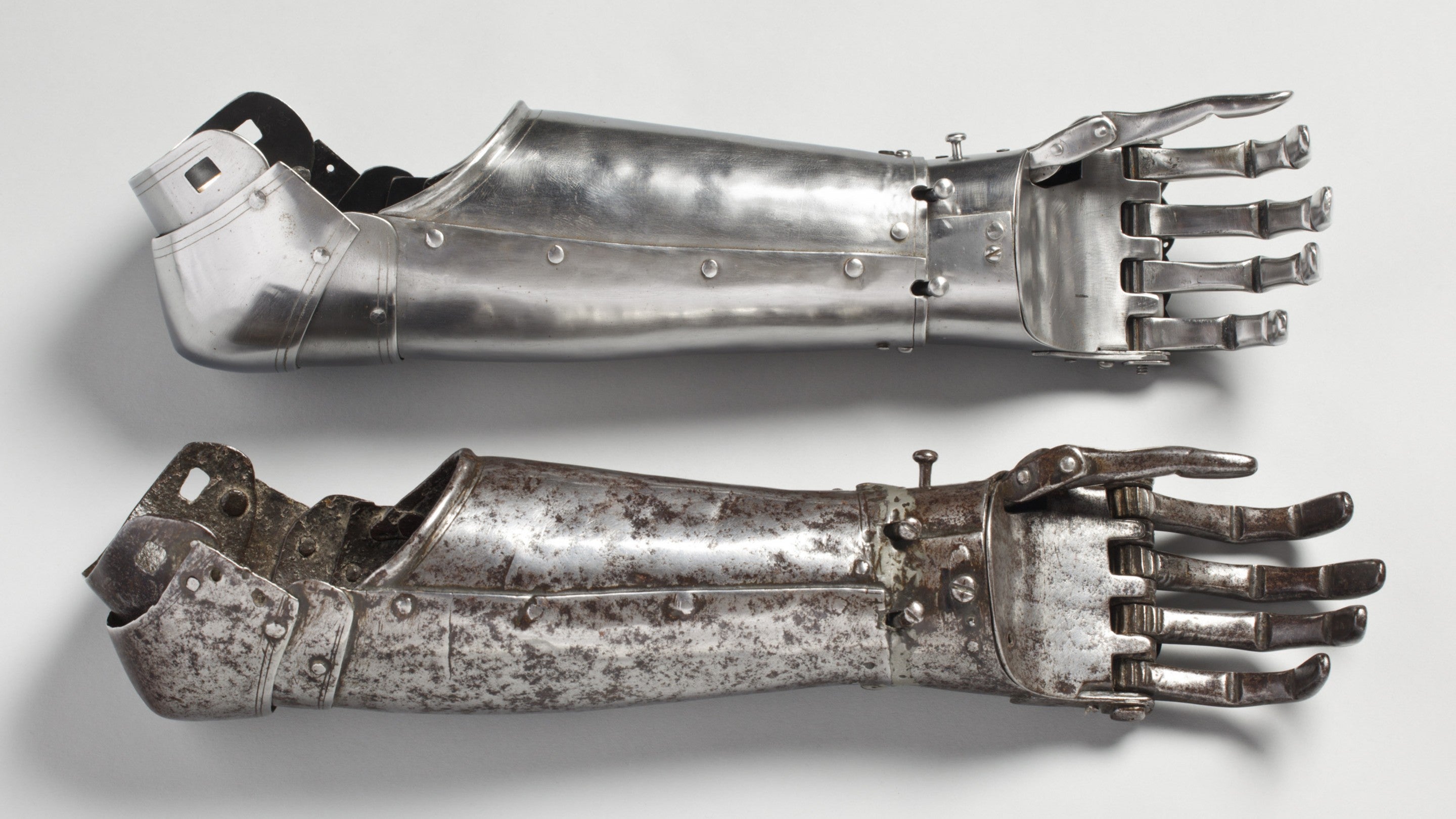 A prosthetic arm made from metal. I has fingers that are moved and locked via a system of small buttons and was made for an injured soldier