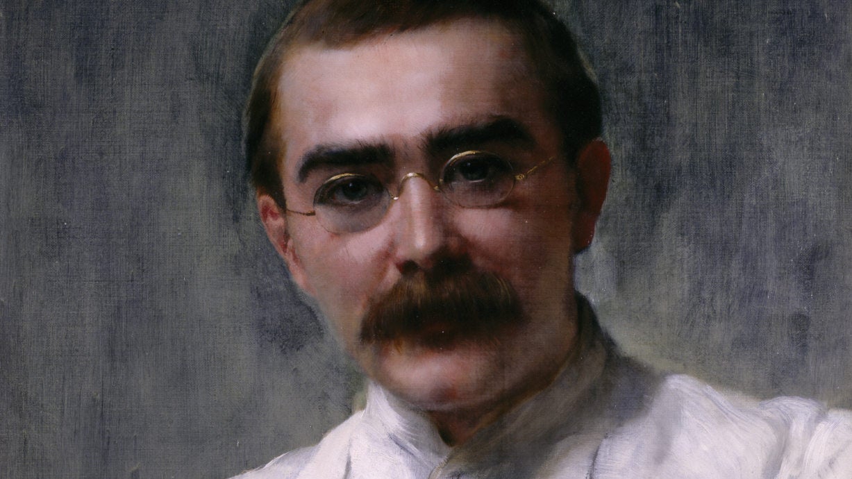 An oil painting of a man with a round face and a bushy moustache. He's wearing small, round spectacles and a white shirt buttoned up to the neck.