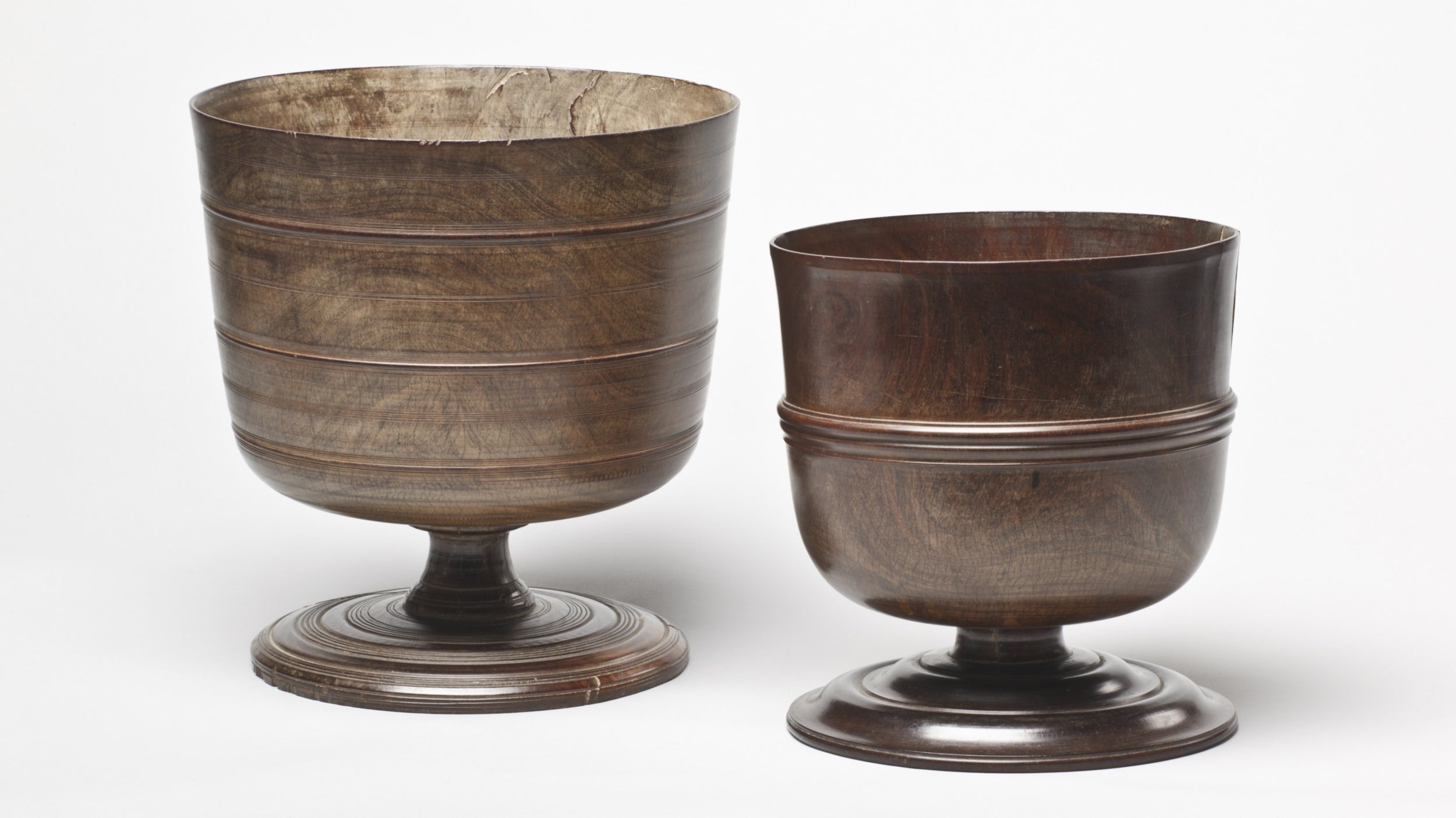 A pair of brown wooden wassail bowls