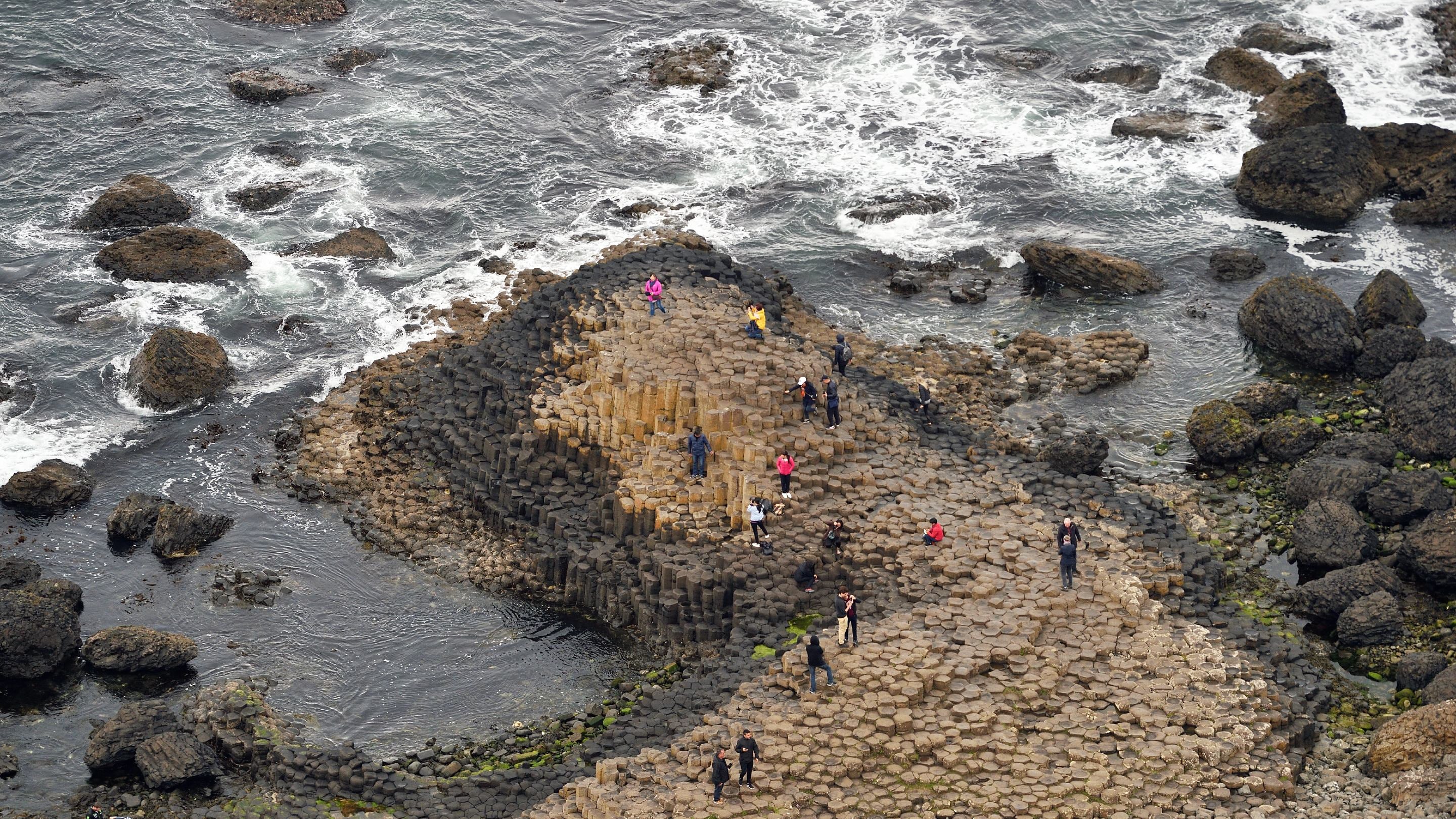 People walking on Giant's Causeway, County Antrim