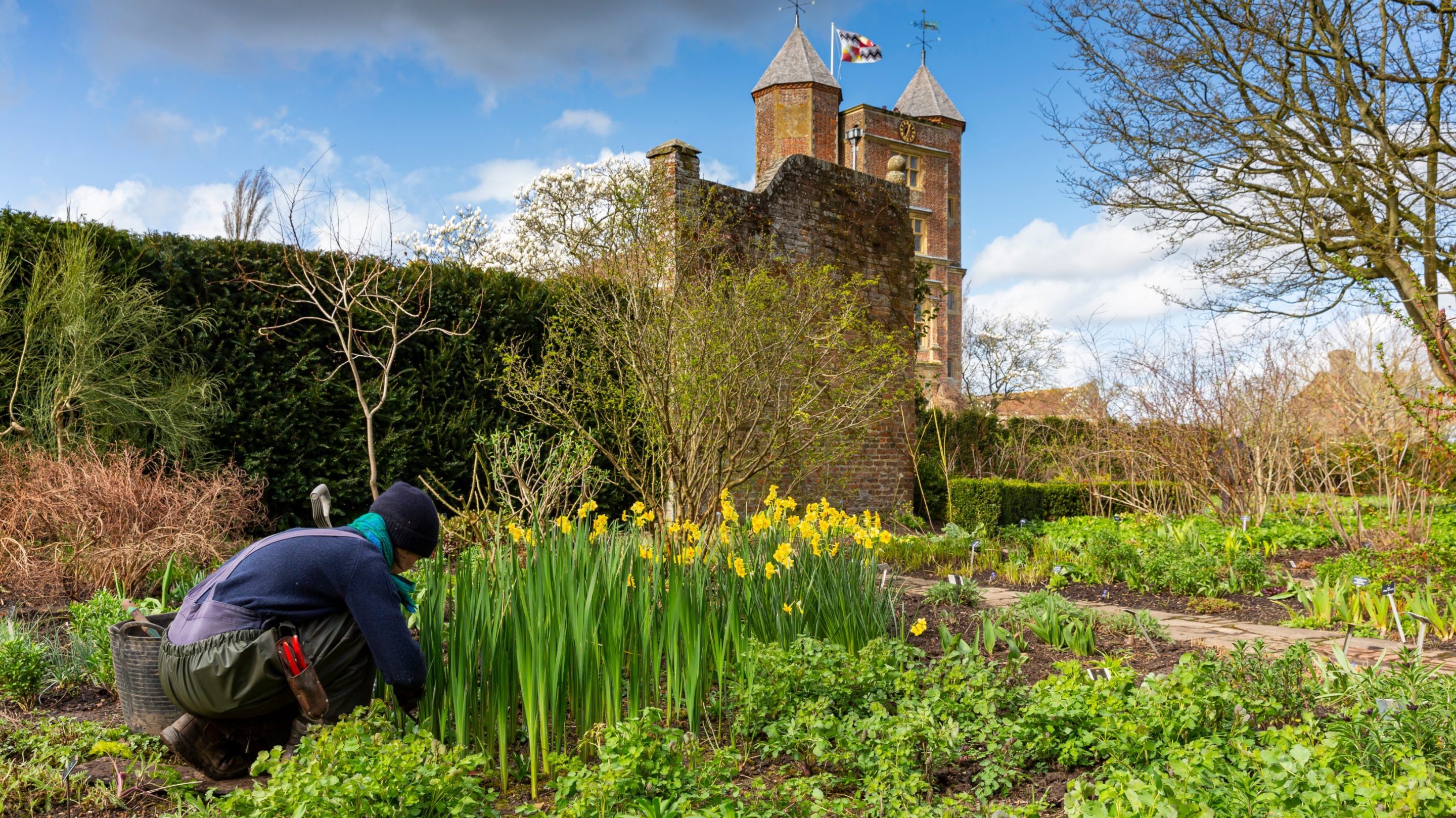 Gardener at work in the South Cottage garden at Sissinghurst Castle Garden, Kent