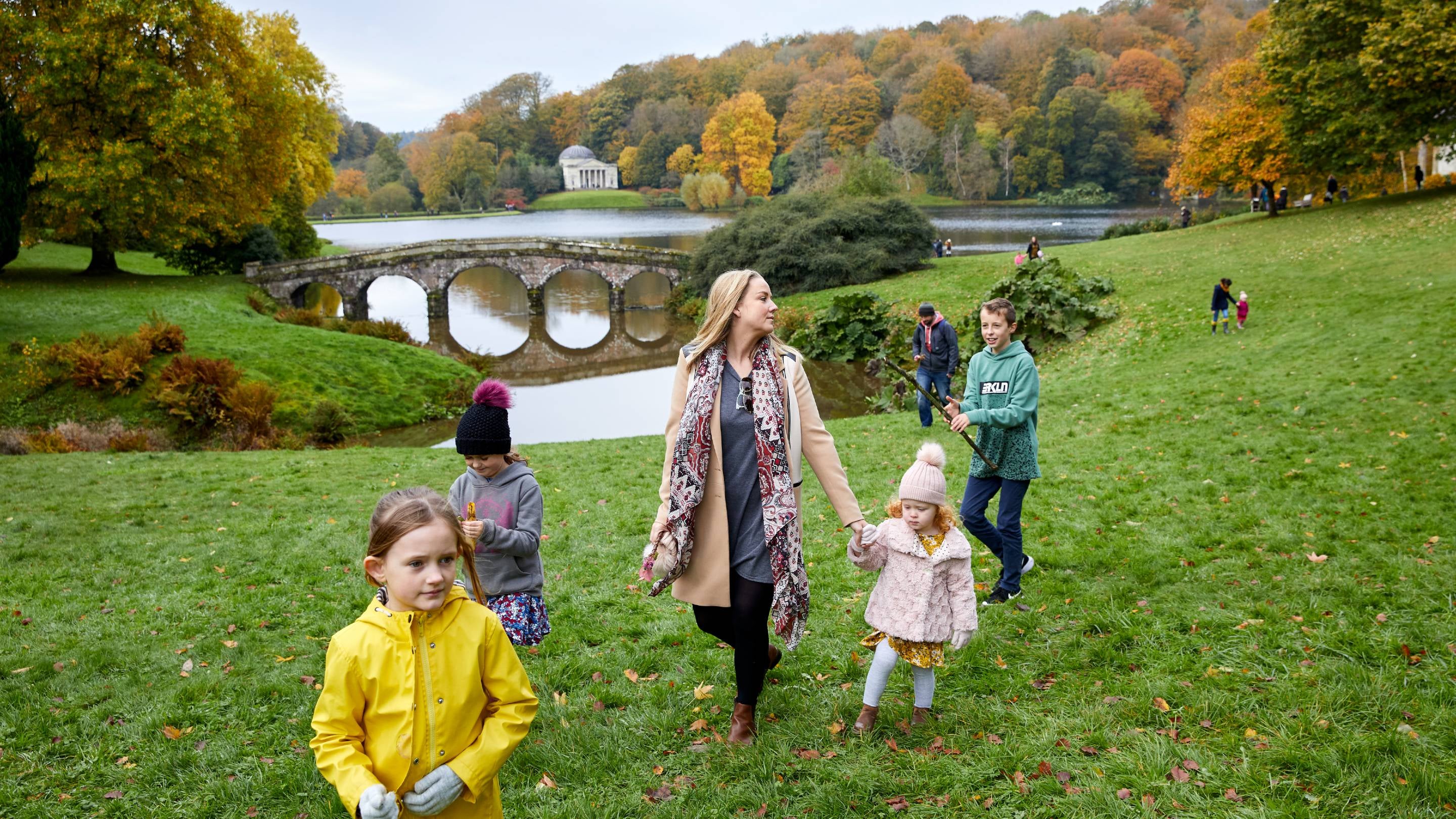 A family enjoys Stourhead's renowned autumn colour