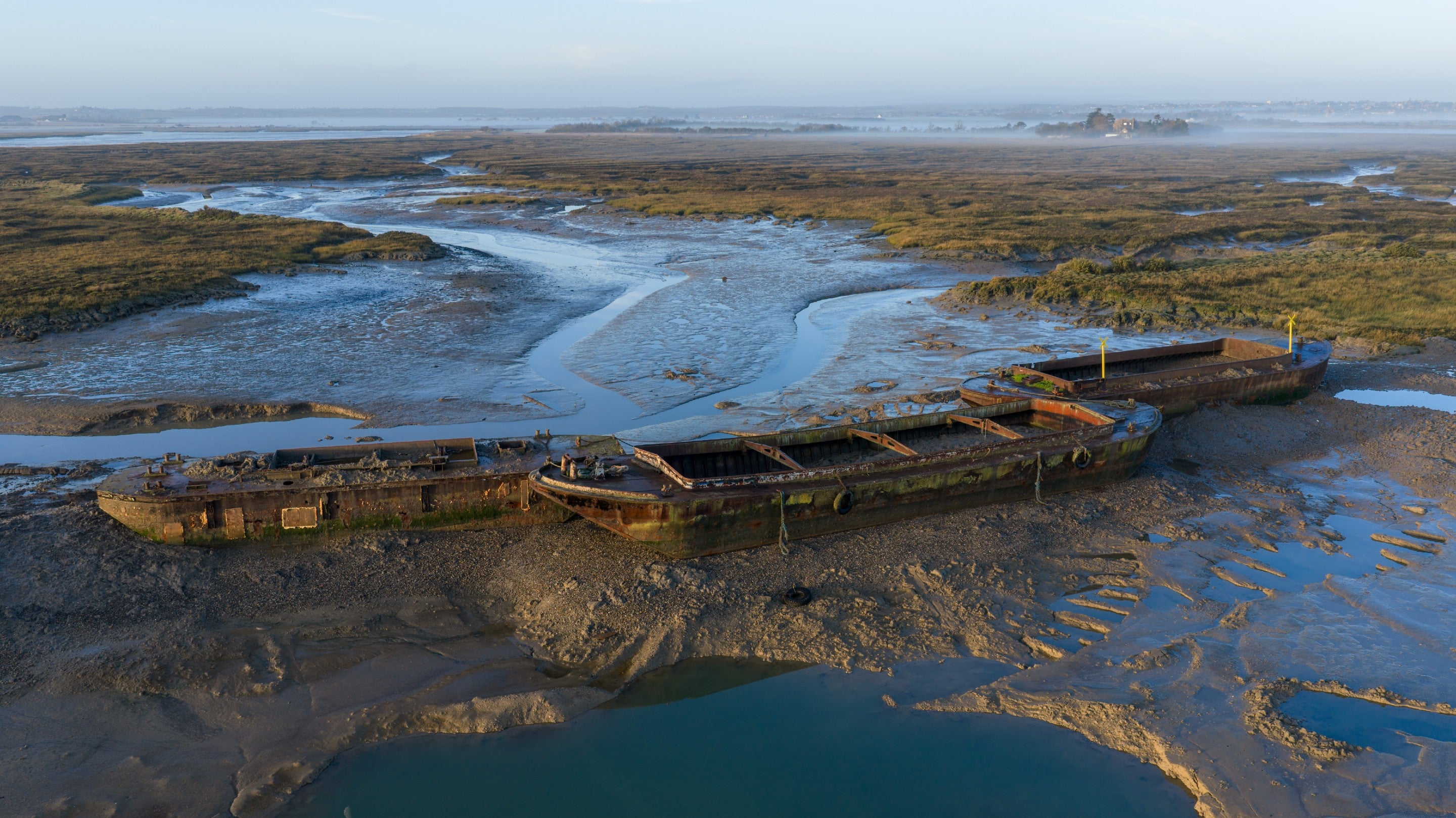 The three barges form the structure of the new island in position at low tide