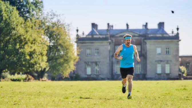 A man running in the parkland at Stourhead