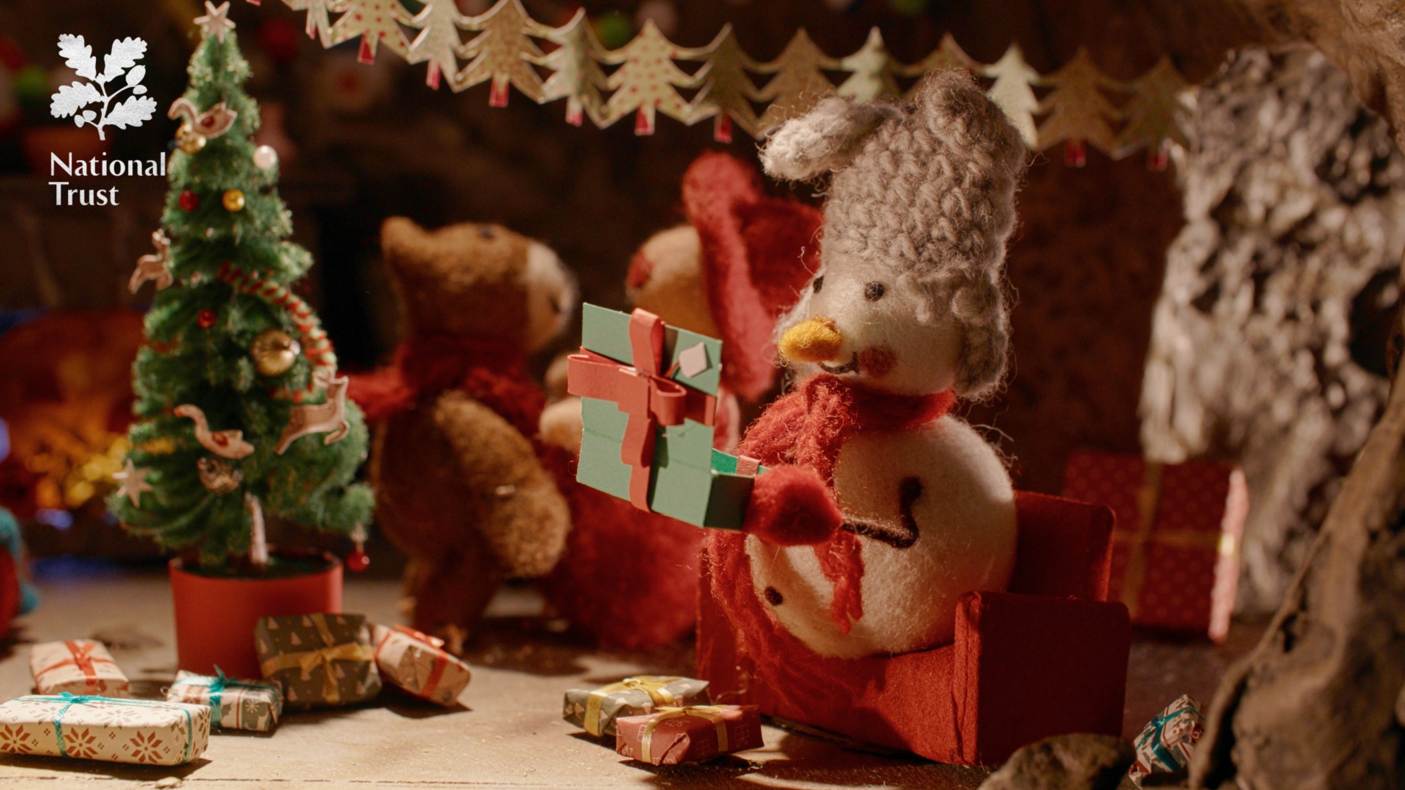 A snowman Christmas decoration opening a present