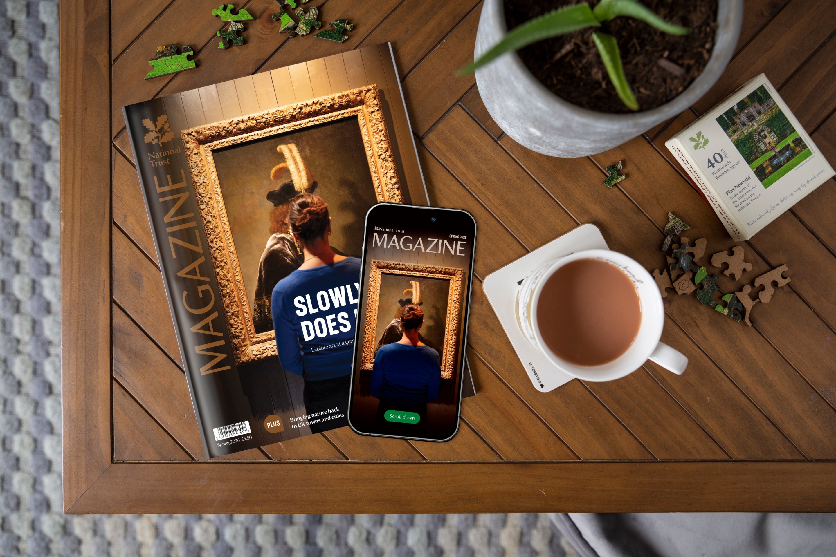 National Trust's Spring 2026 magazine on a coffee table with a mobile phone