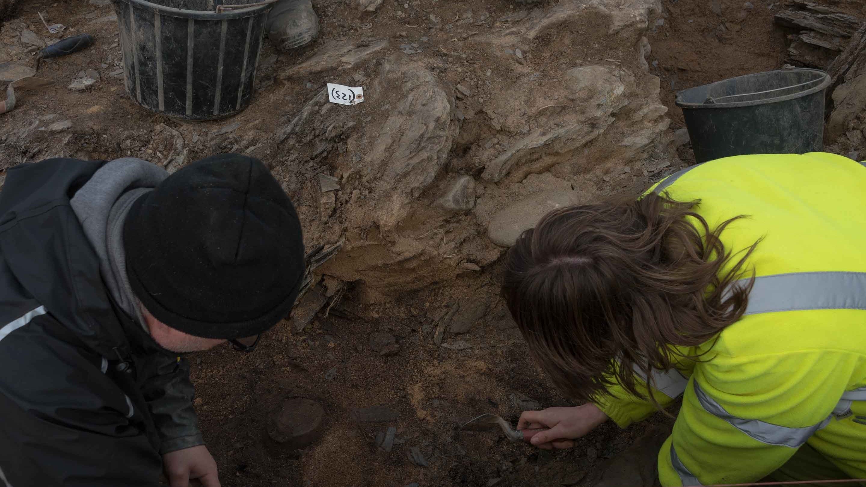 Close-up of two archaeologists doing detailed excavation work at Trevose Head, Cornwall