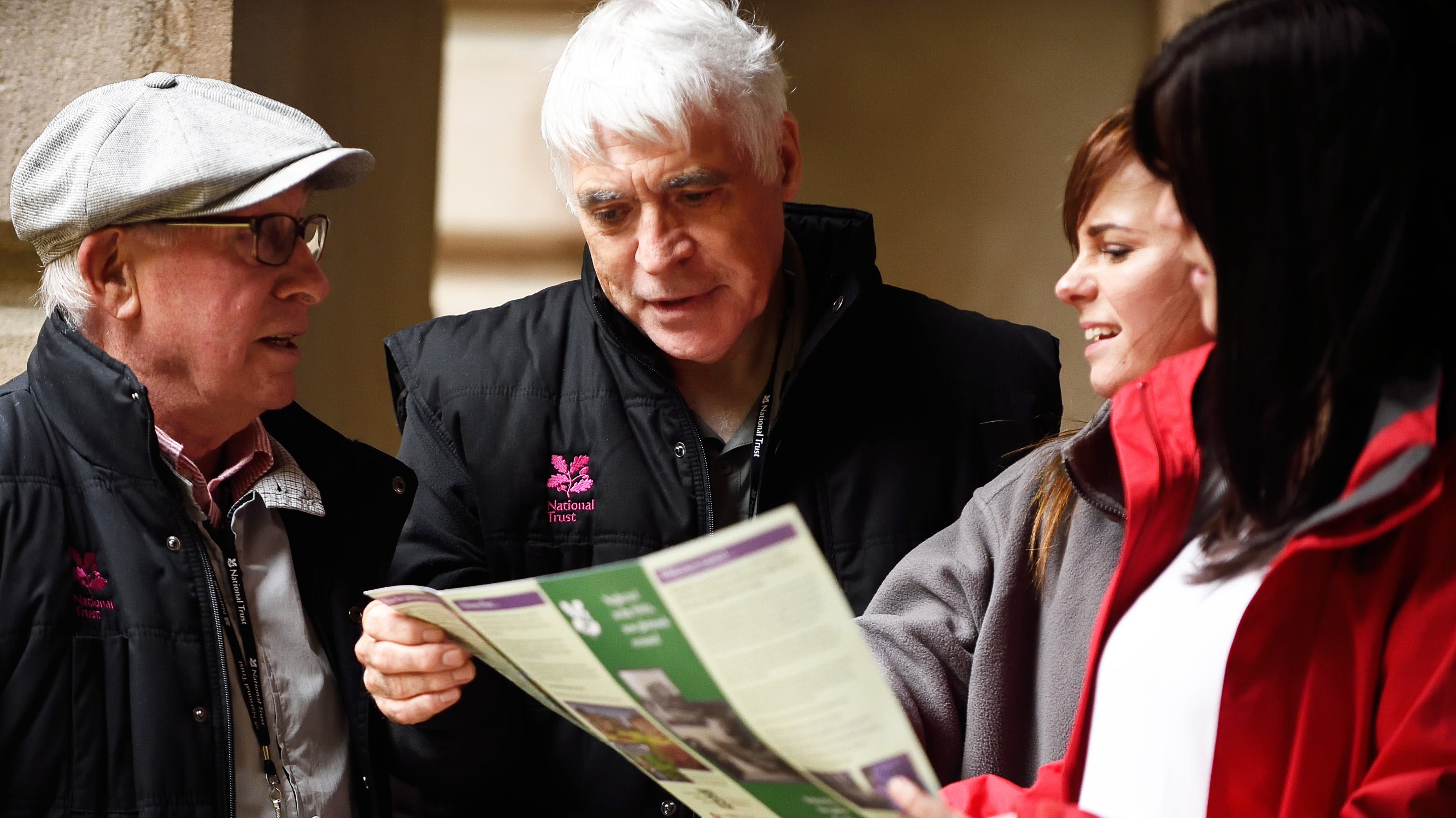 Two guides taking to two visitors in close up