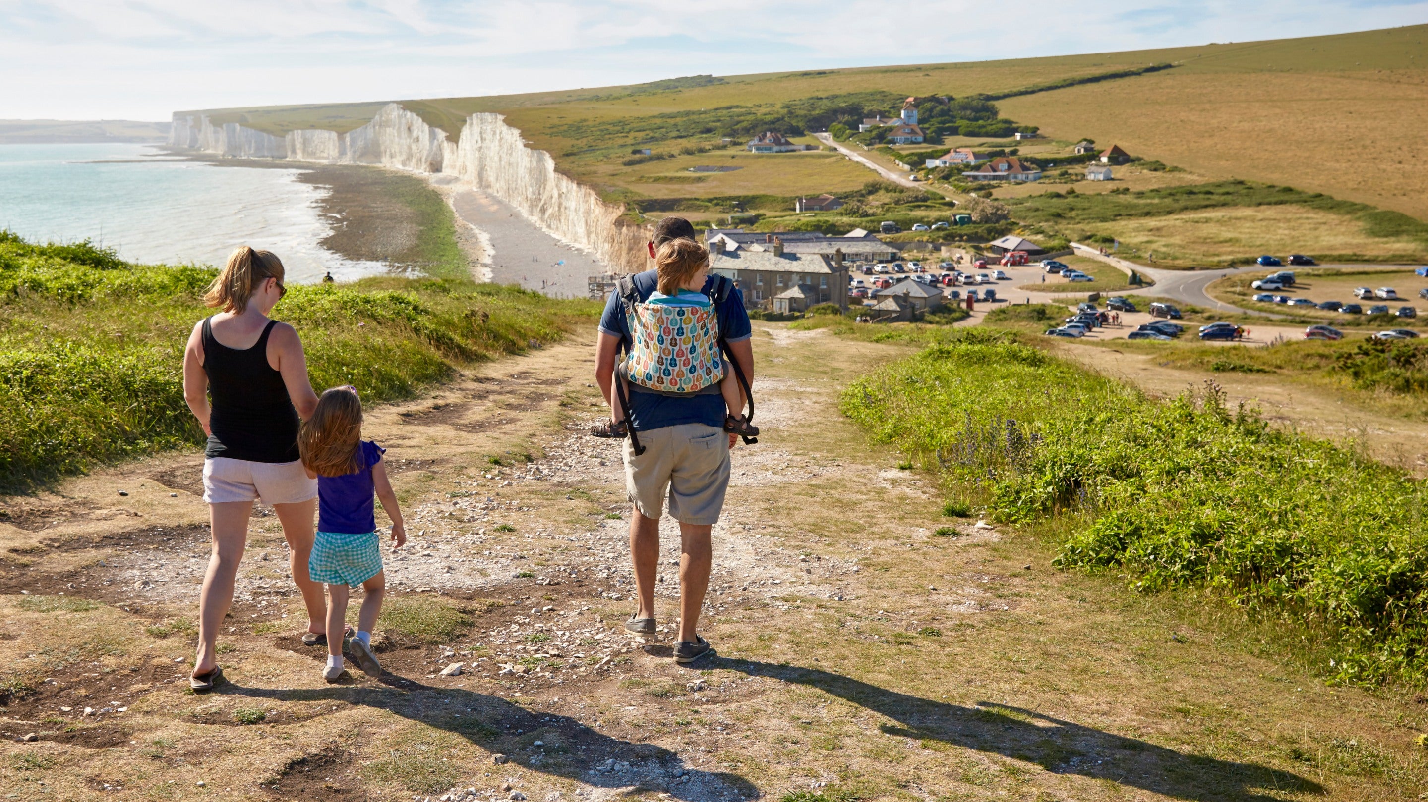 A family walking at Birling Gap and the Seven Sisters, East Sussex.