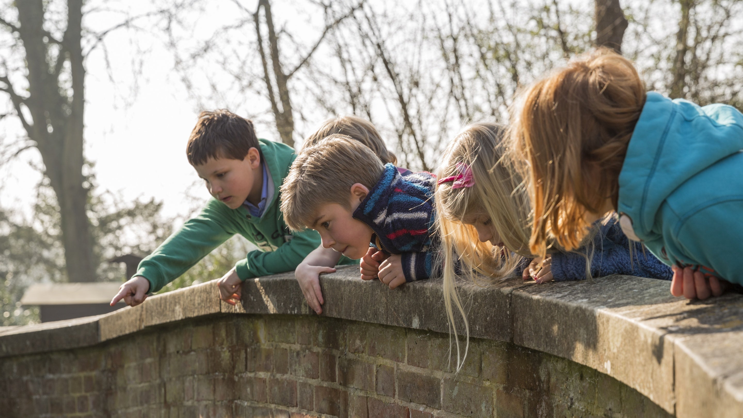 Children looking over a bridge at Mottisfont, Hampshire