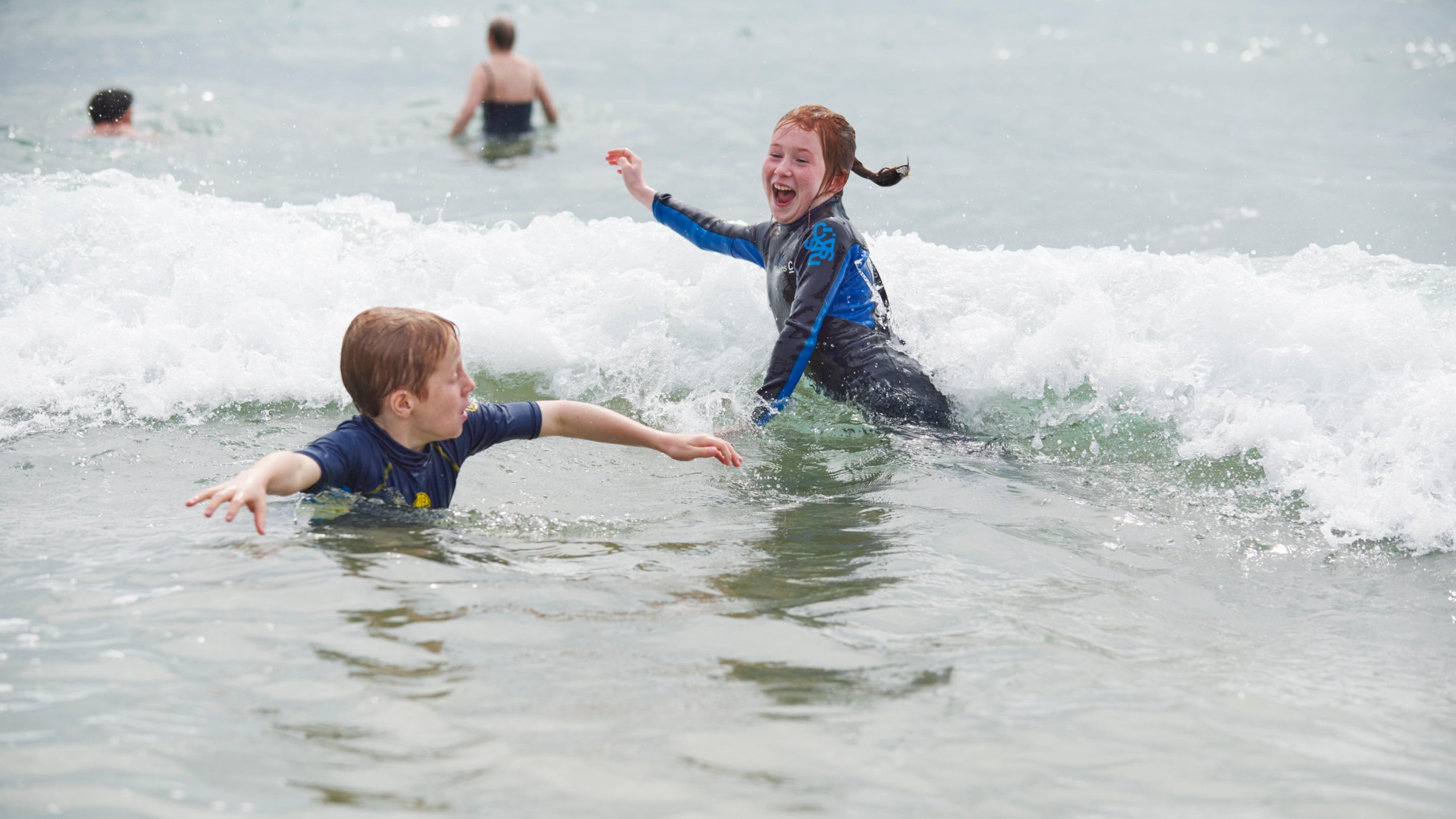 Children swimming in the sea at Soar Mill Cove in Devon