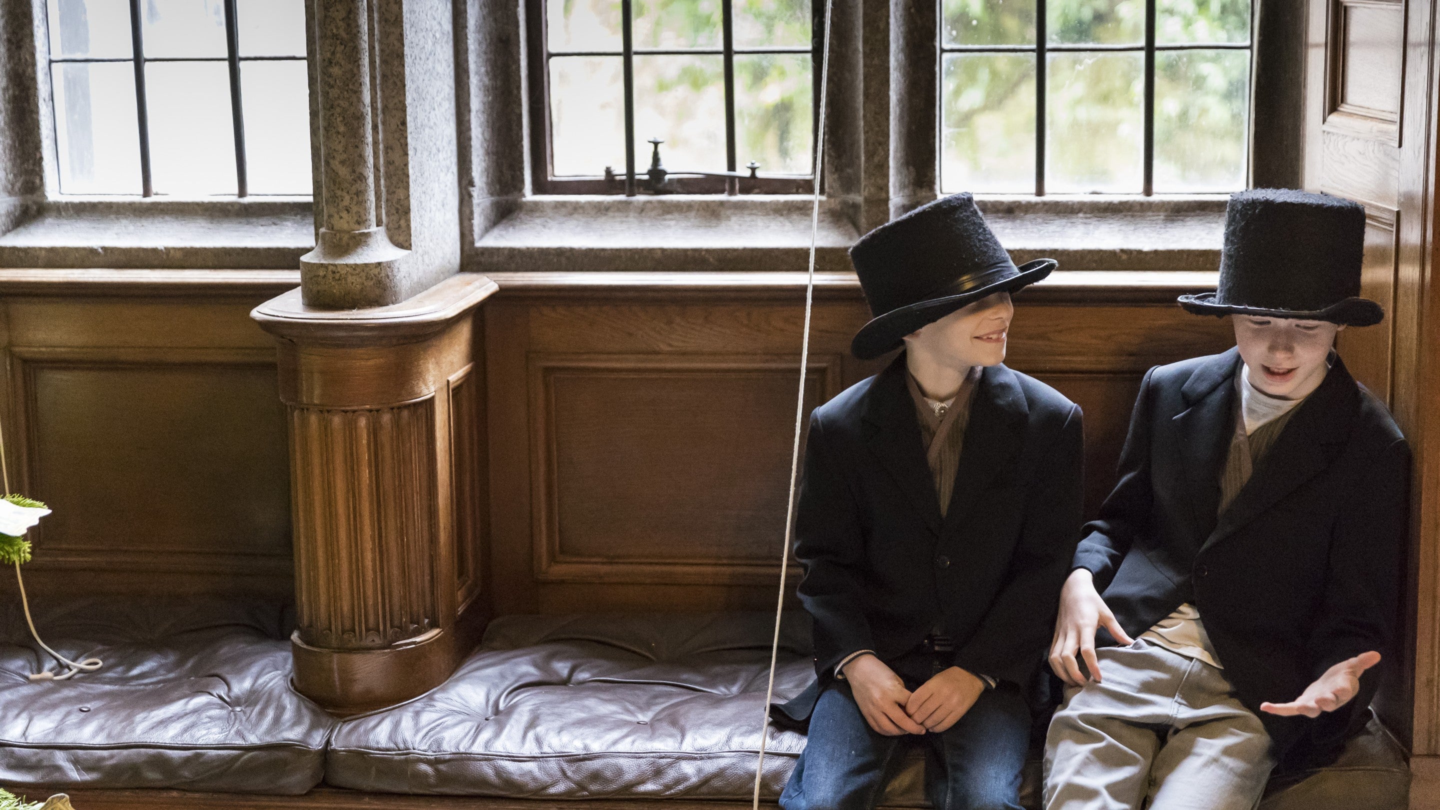 Children trying on Victorian style clothes at Lanhydrock, Cornwall