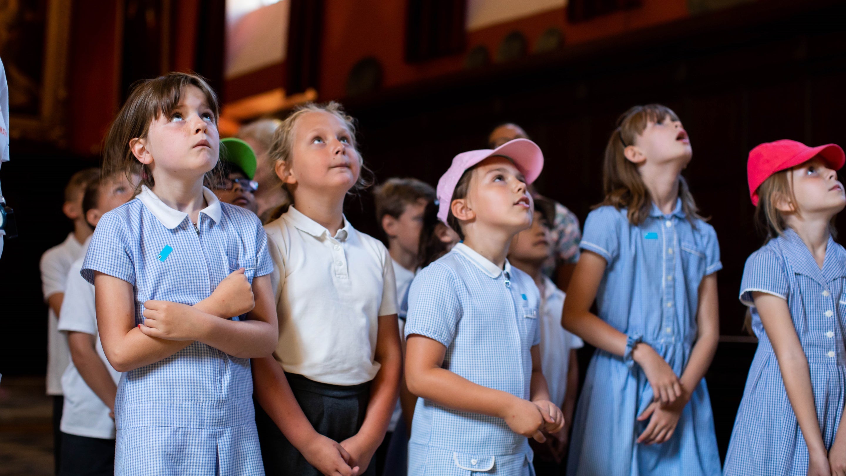 School children looking up in the Great Hall at Knole, Kent