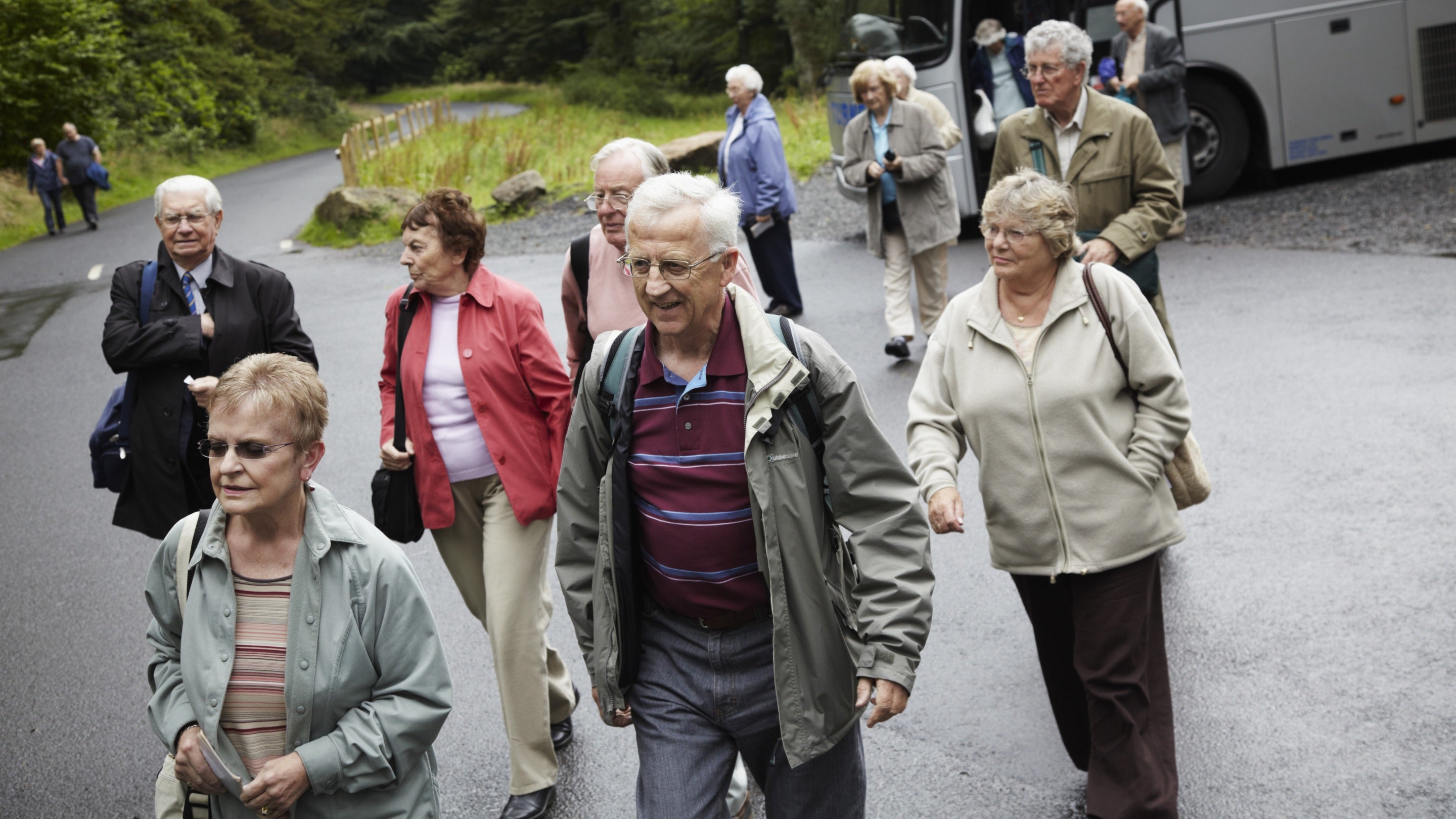 Visitors on a group tour leaving the coach at Cragside, Northumberland