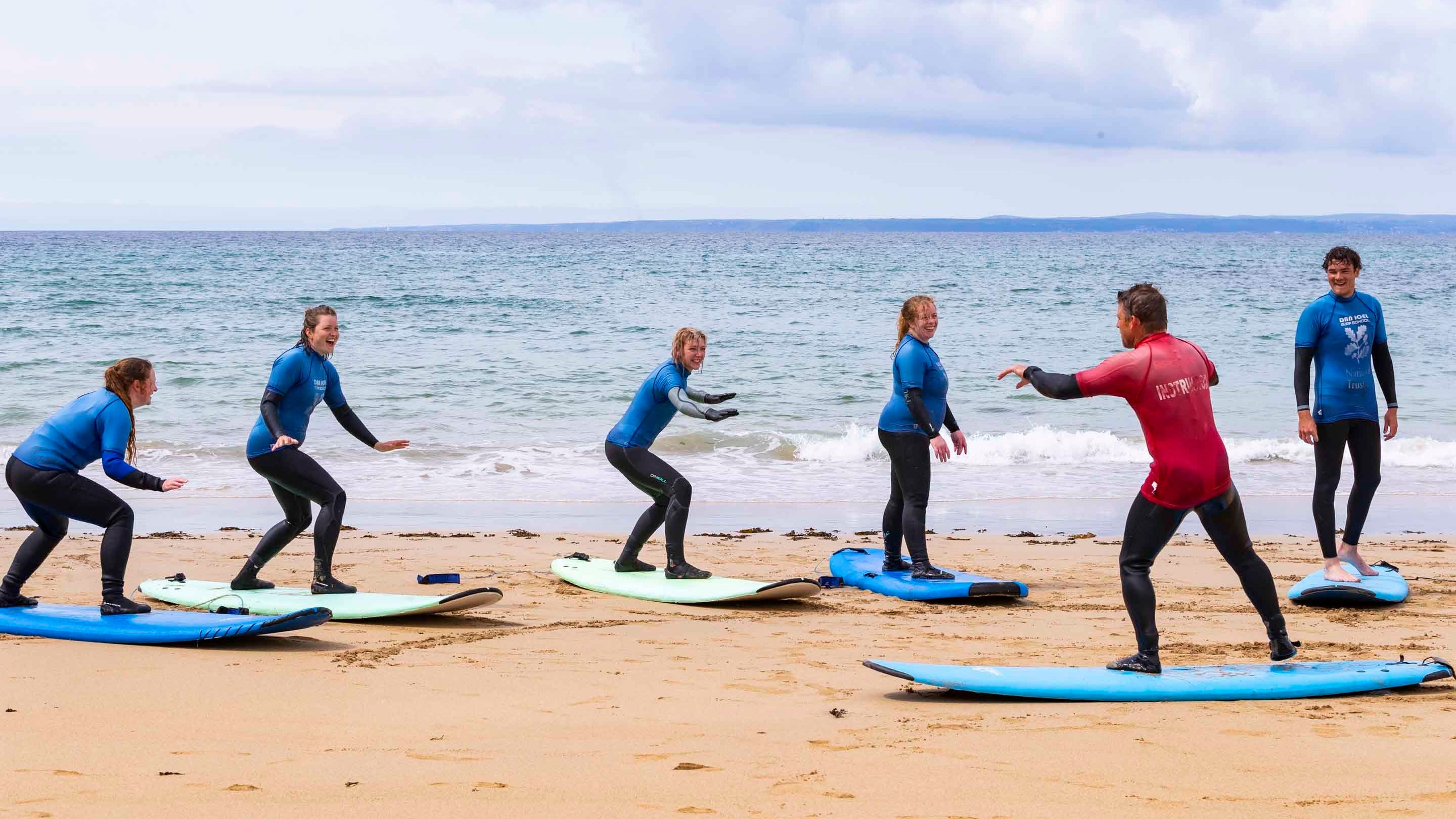 Surfing lesson at Poldhu Beach, Cornwall