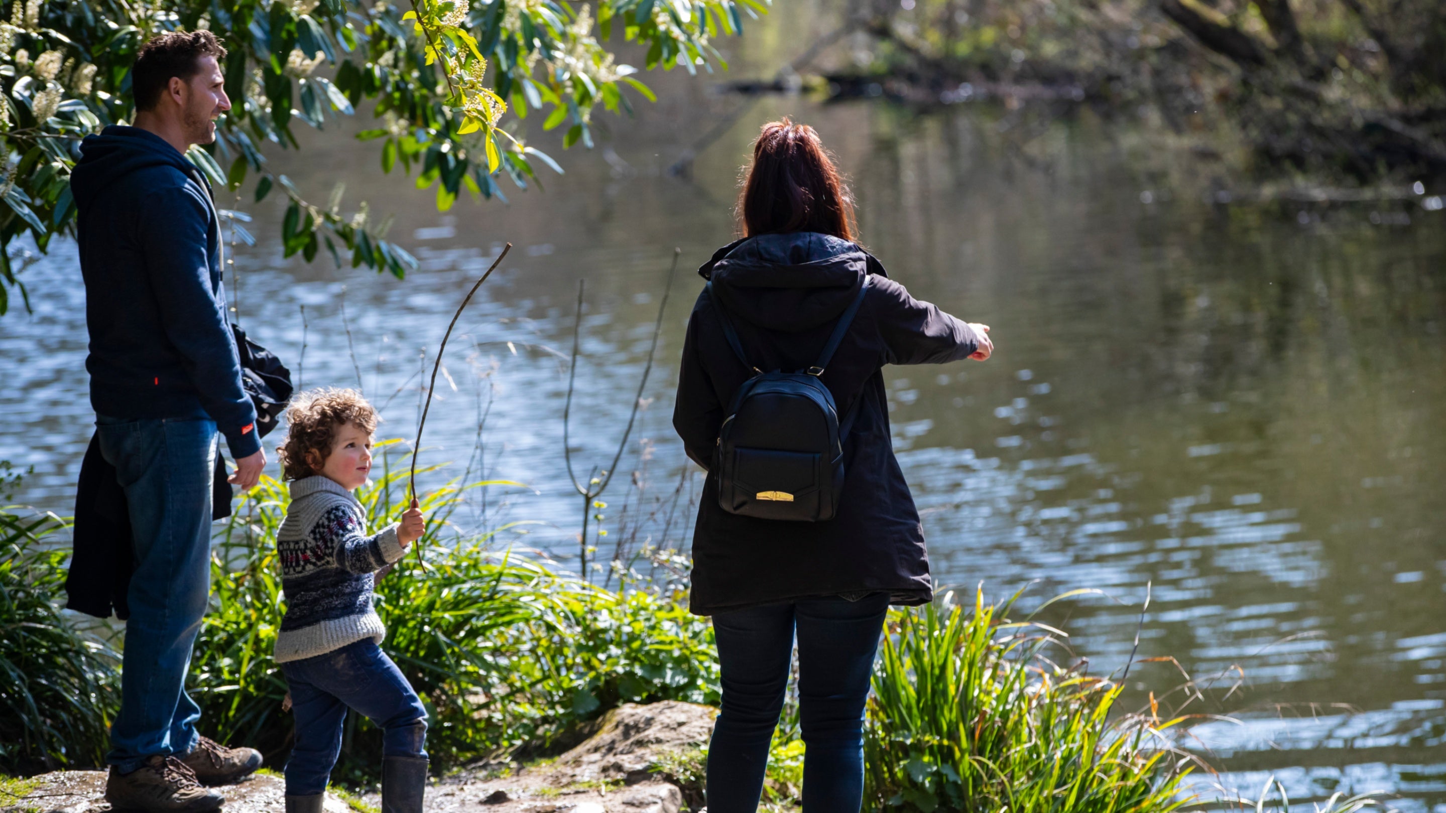 Family visitors by the lake at Woodchester Park, Gloucestershire