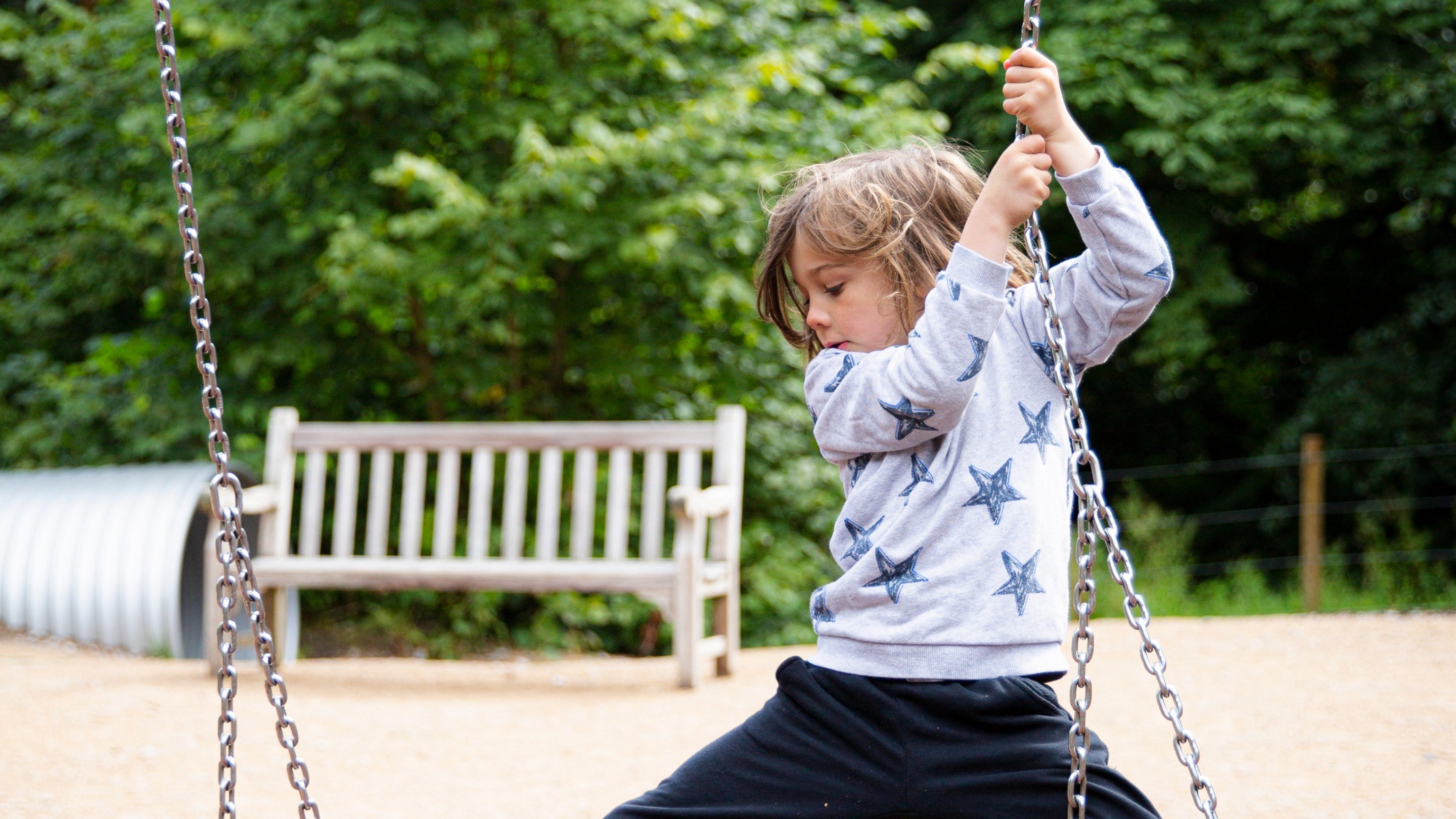 A child playing in the Crow Wood play area at Lyme Park, Cheshire